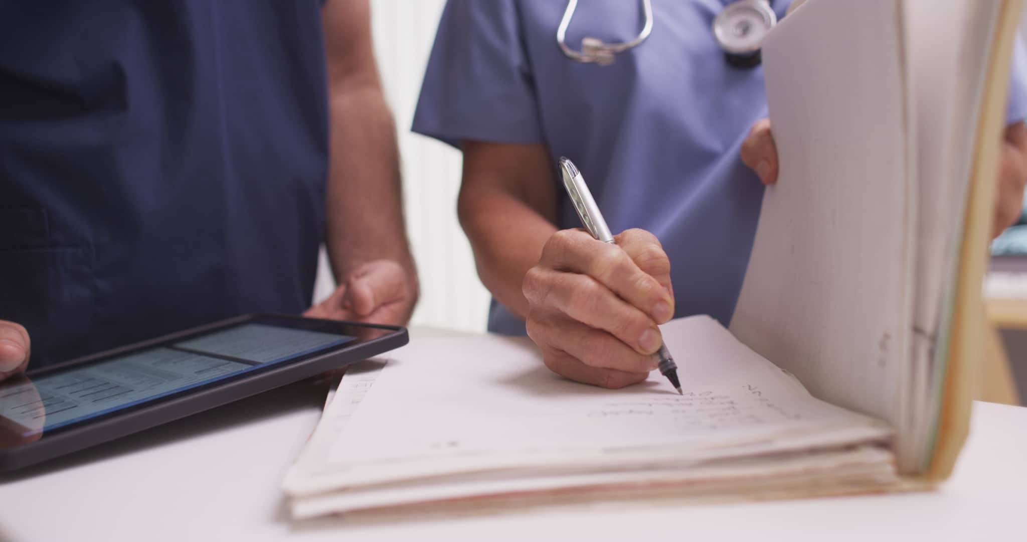 Medical professionals discussing paperwork