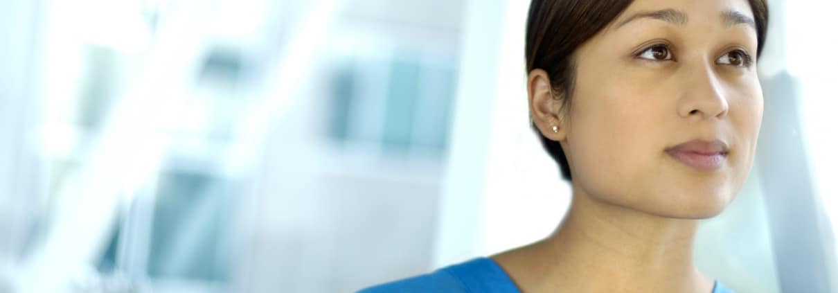 Nurse in scrubs looking forward