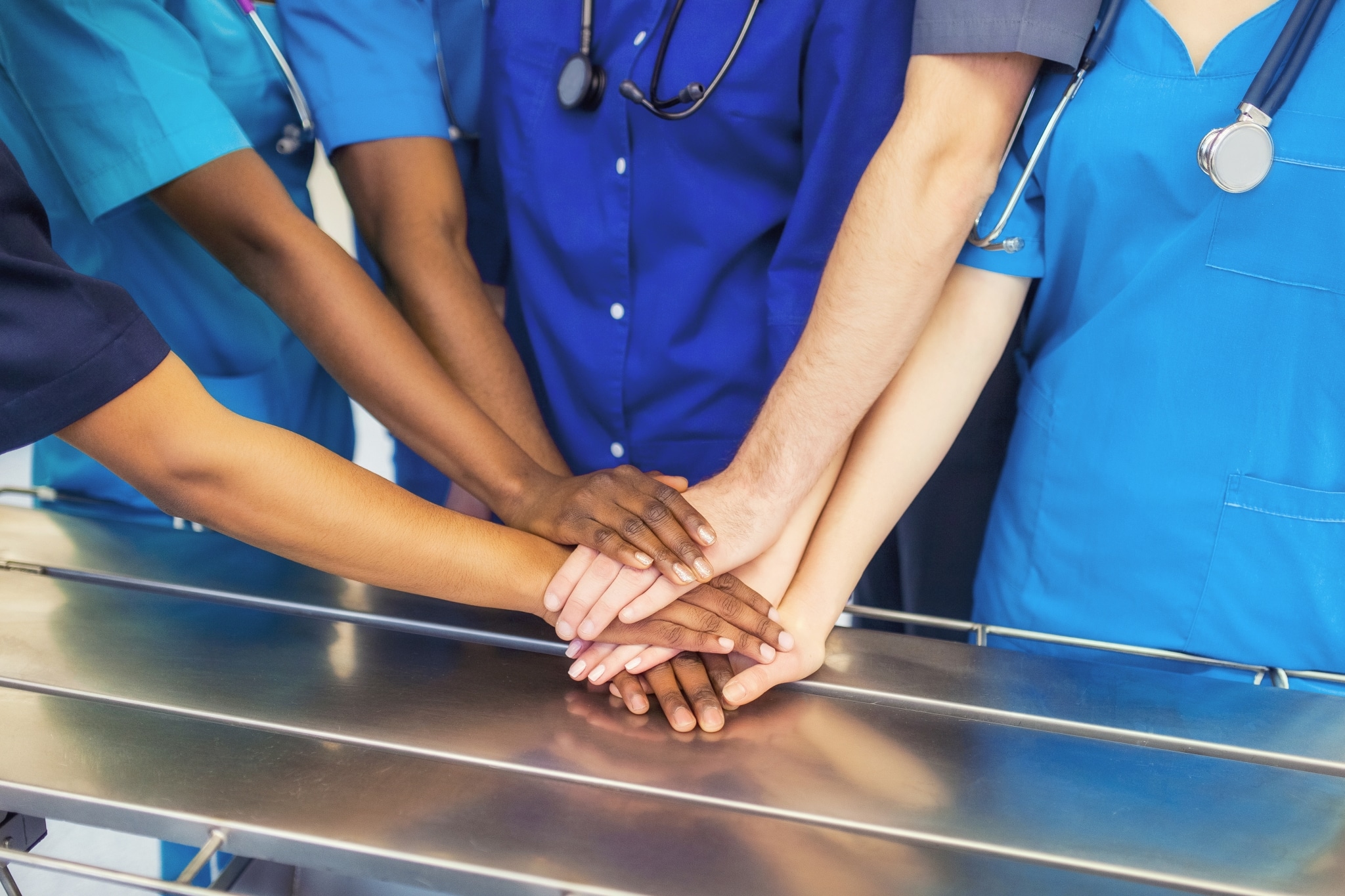 Healthcare professionals joining hands