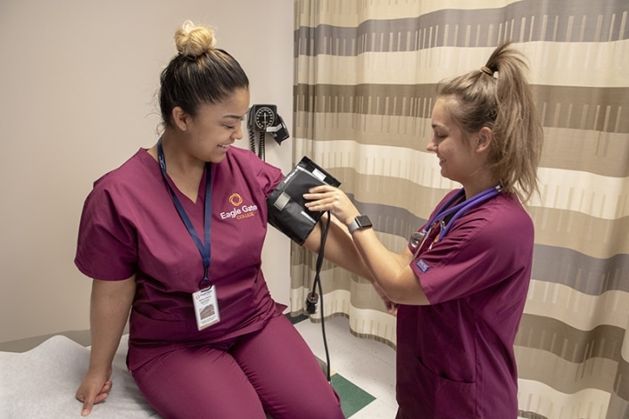 Student checking another's blood pressure