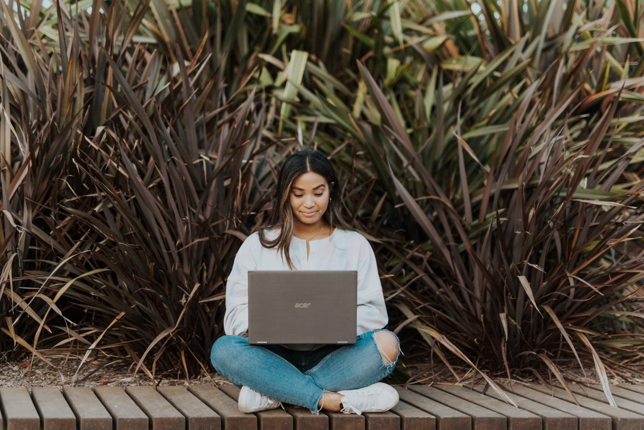 Woman on her laptop outside
