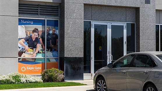 Entrance to Eagle Gate College with banner showcasing a student nurse