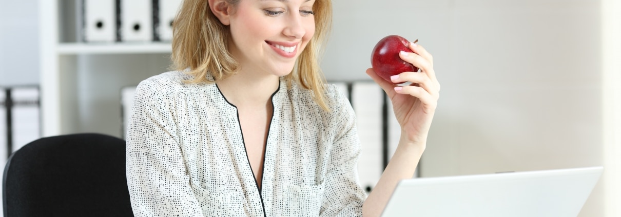 Healthy businesswoman with an apple