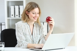 Healthy businesswoman with an apple