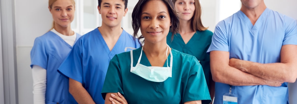 Medical professionals smiling in a hallway