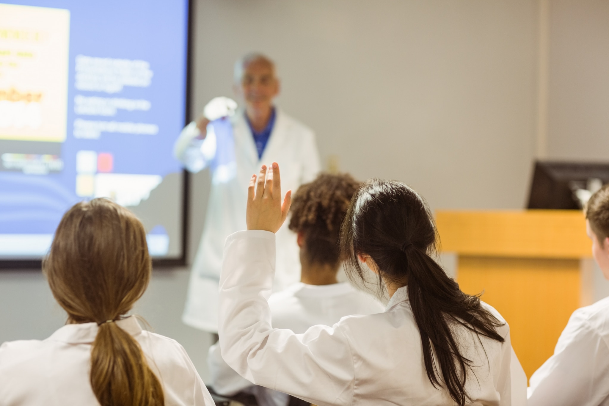 Medical students asking a professor questions