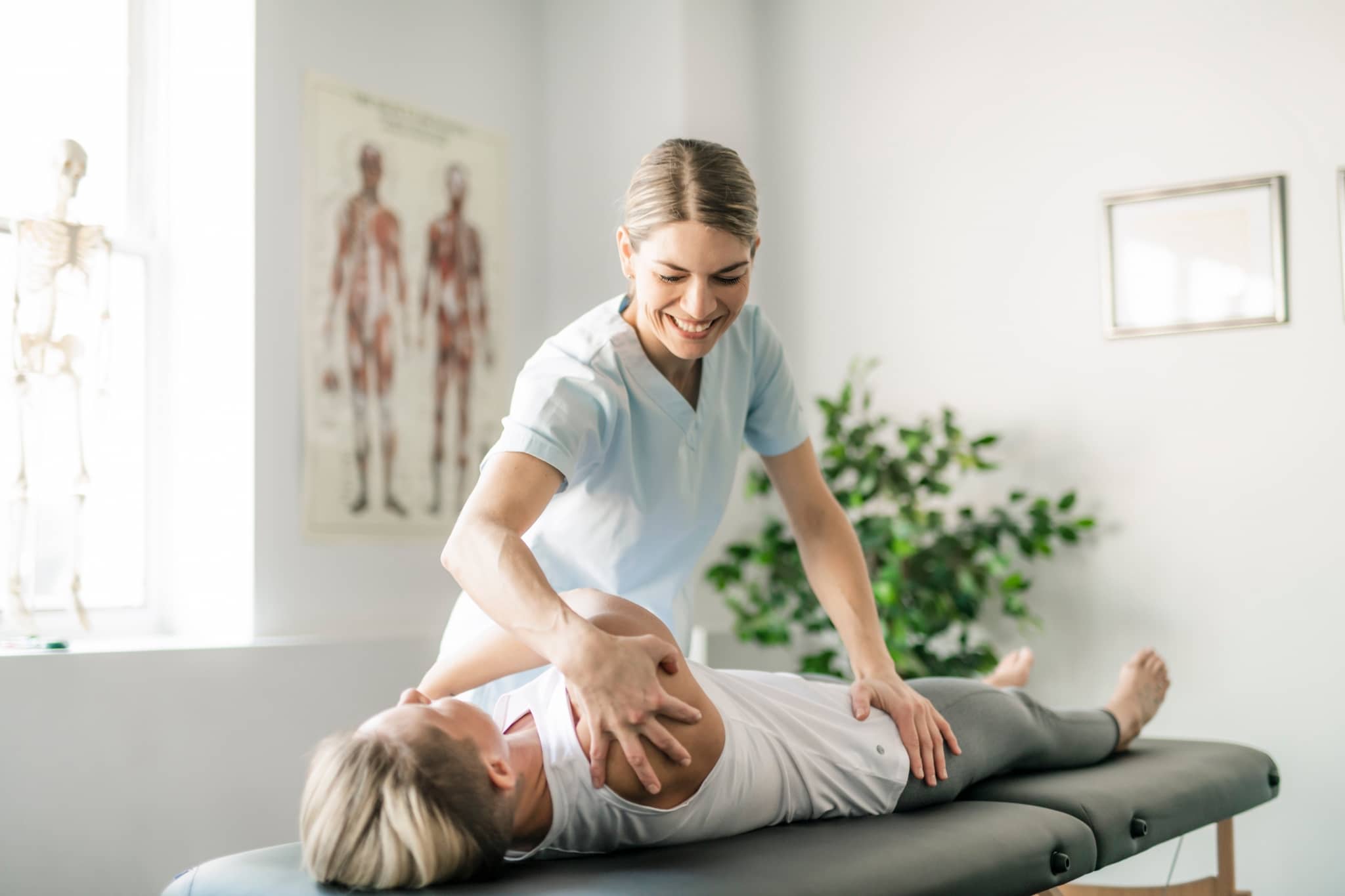 Physiotherapy professional helping a female client