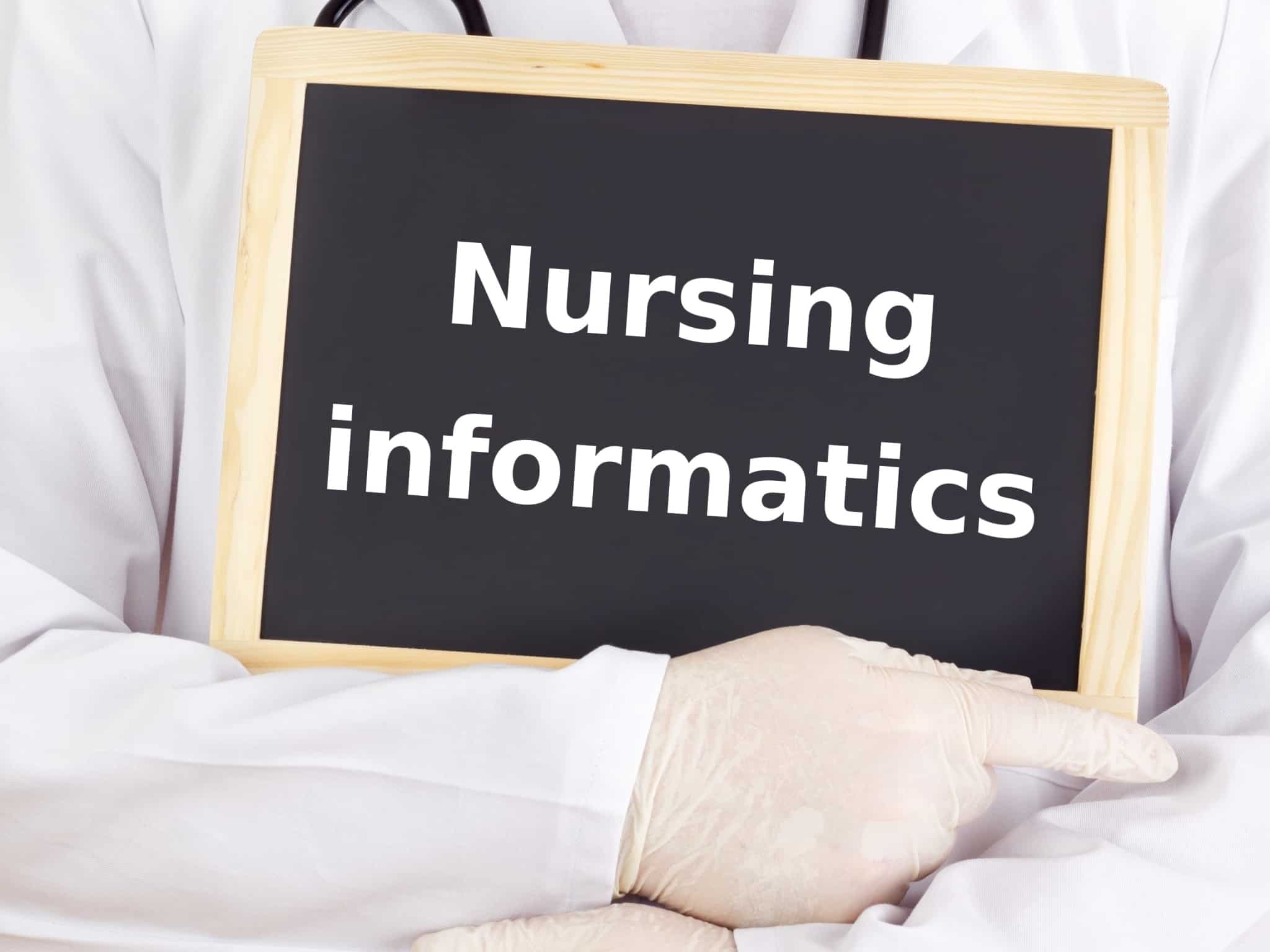 Nurse holding a nursing informatics sign