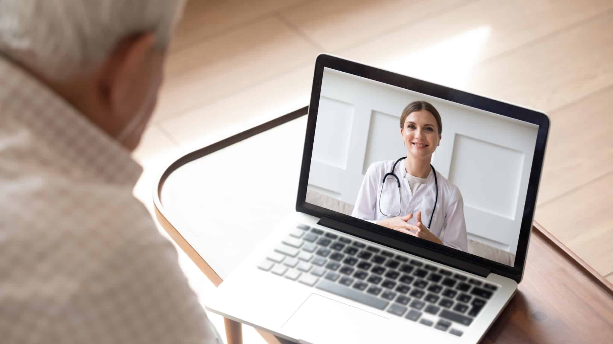 Elderly man virtually meeting with a medical consultant