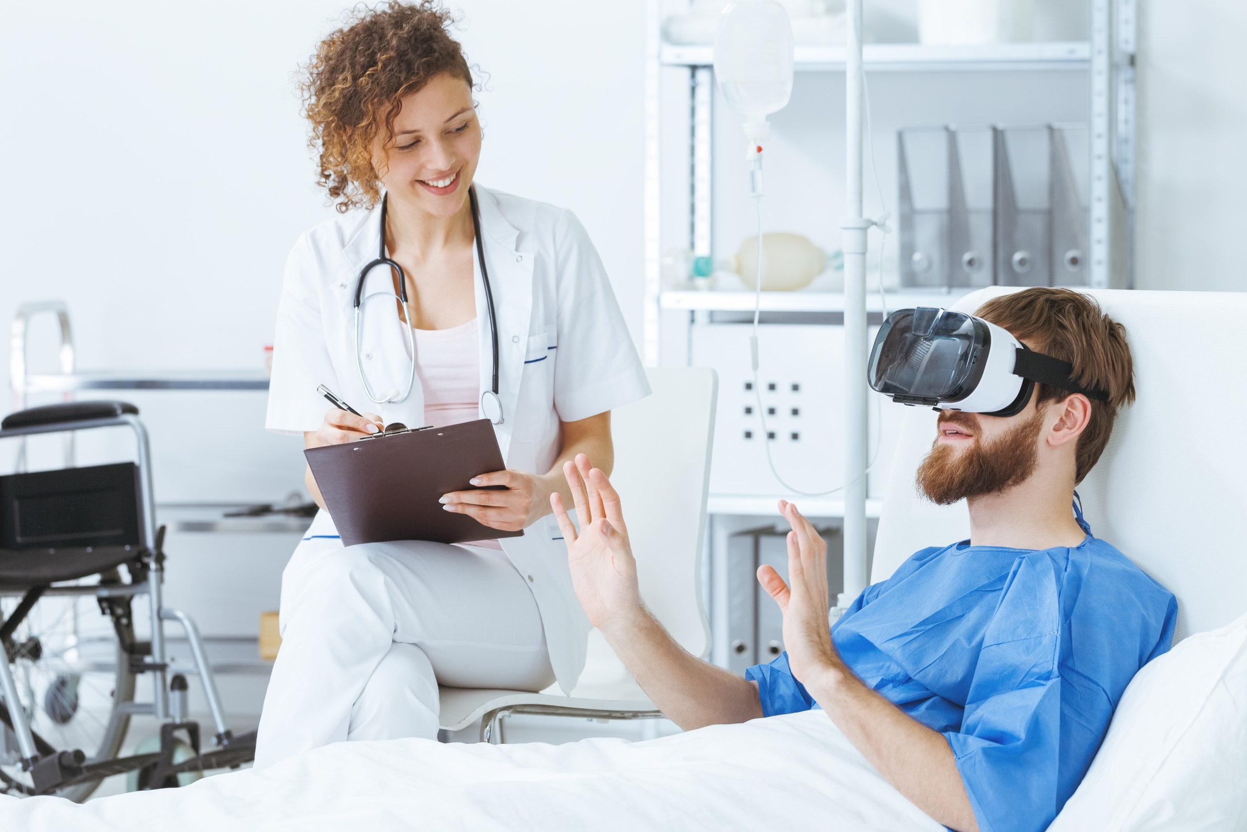 Psychiatric nurse with patient wearing a VR headset