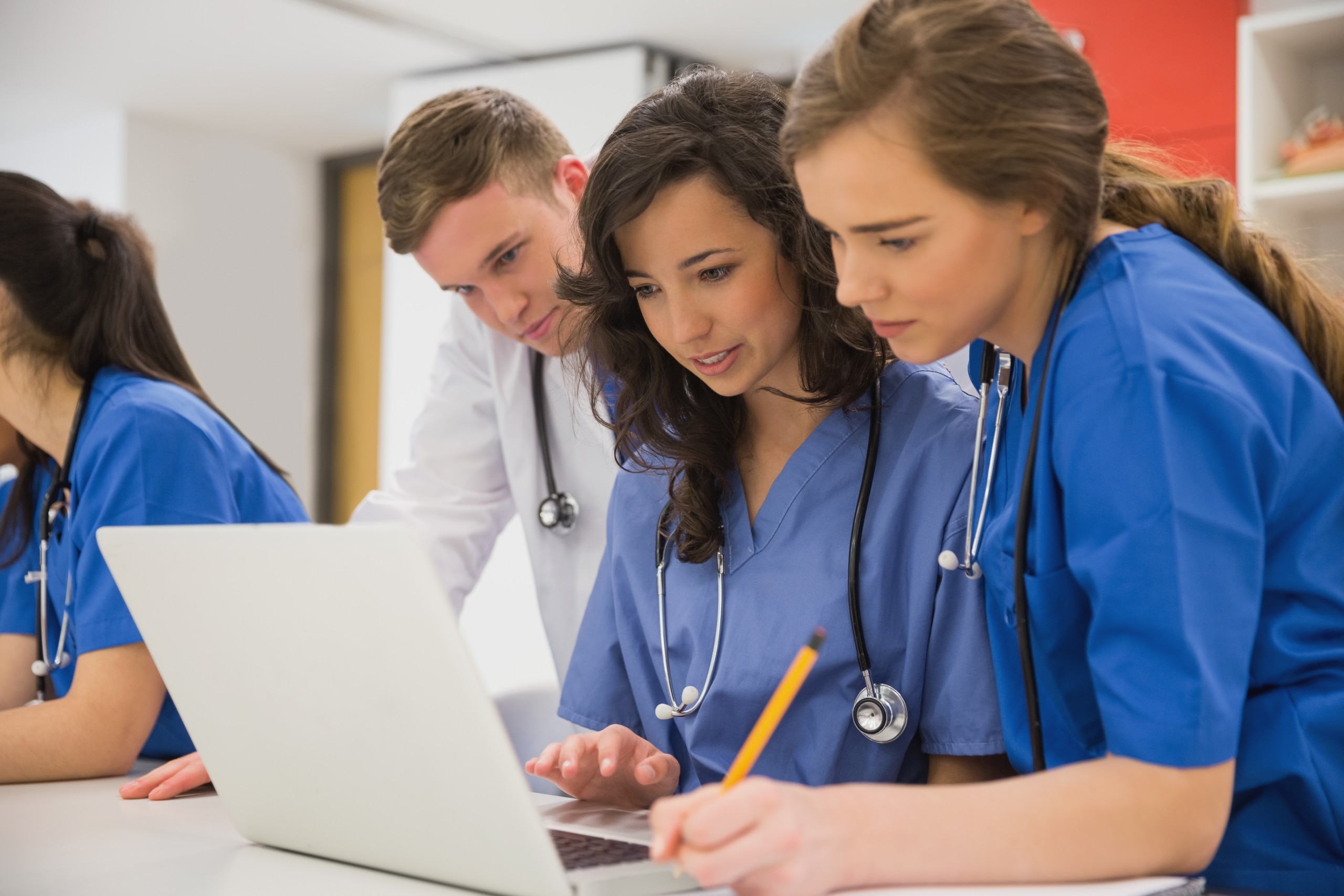 Medical students looking at a laptop