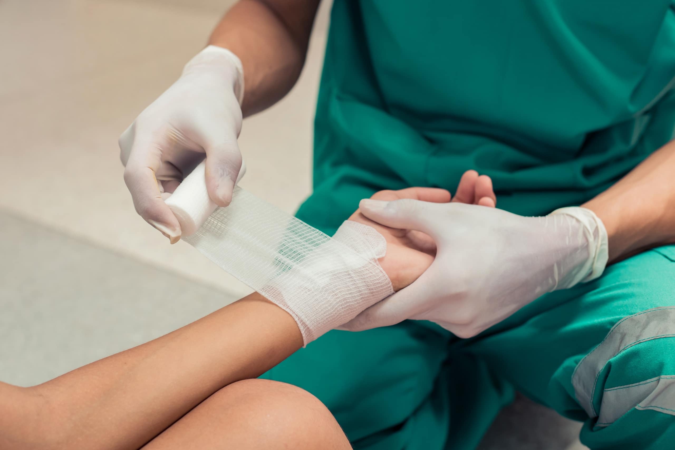 Medical professional bandaging a wound