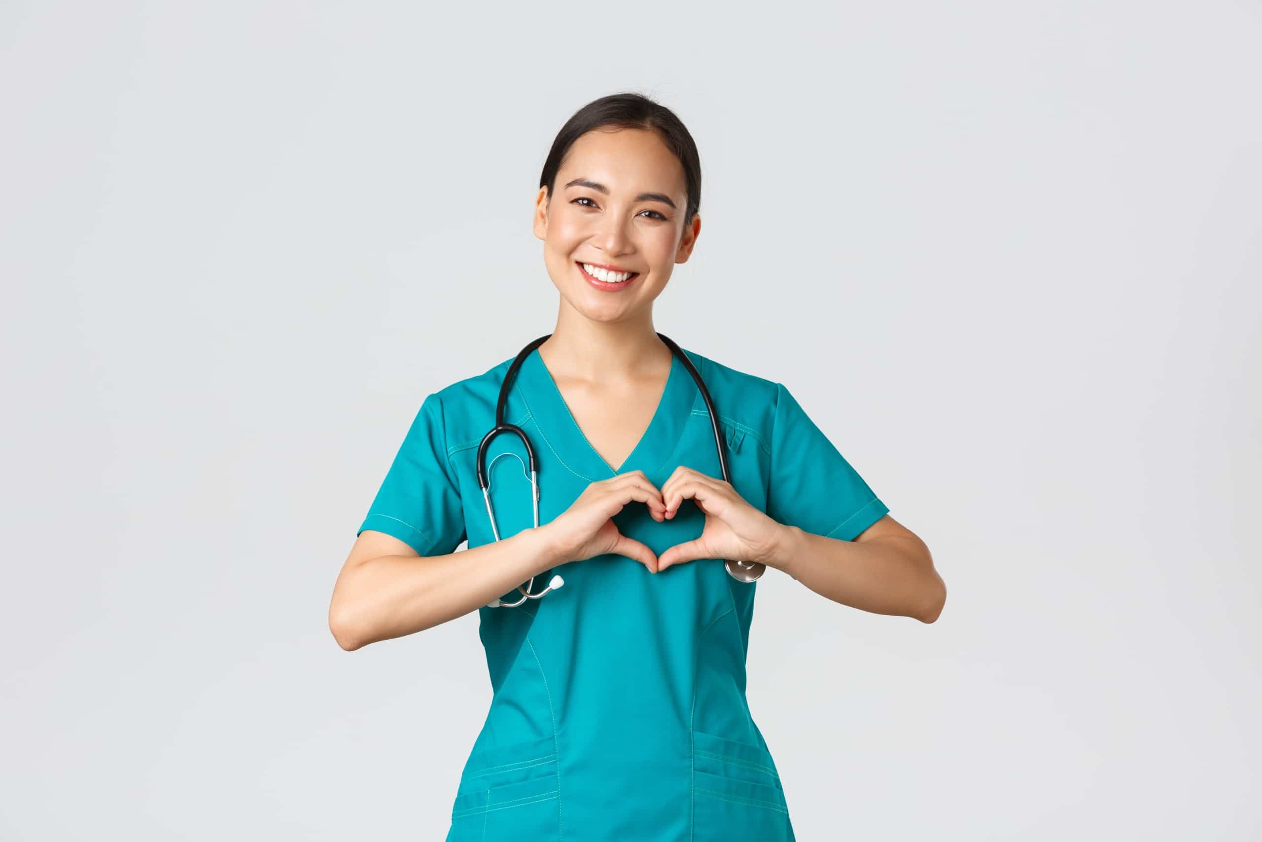 Nurse forming a heart with her hands