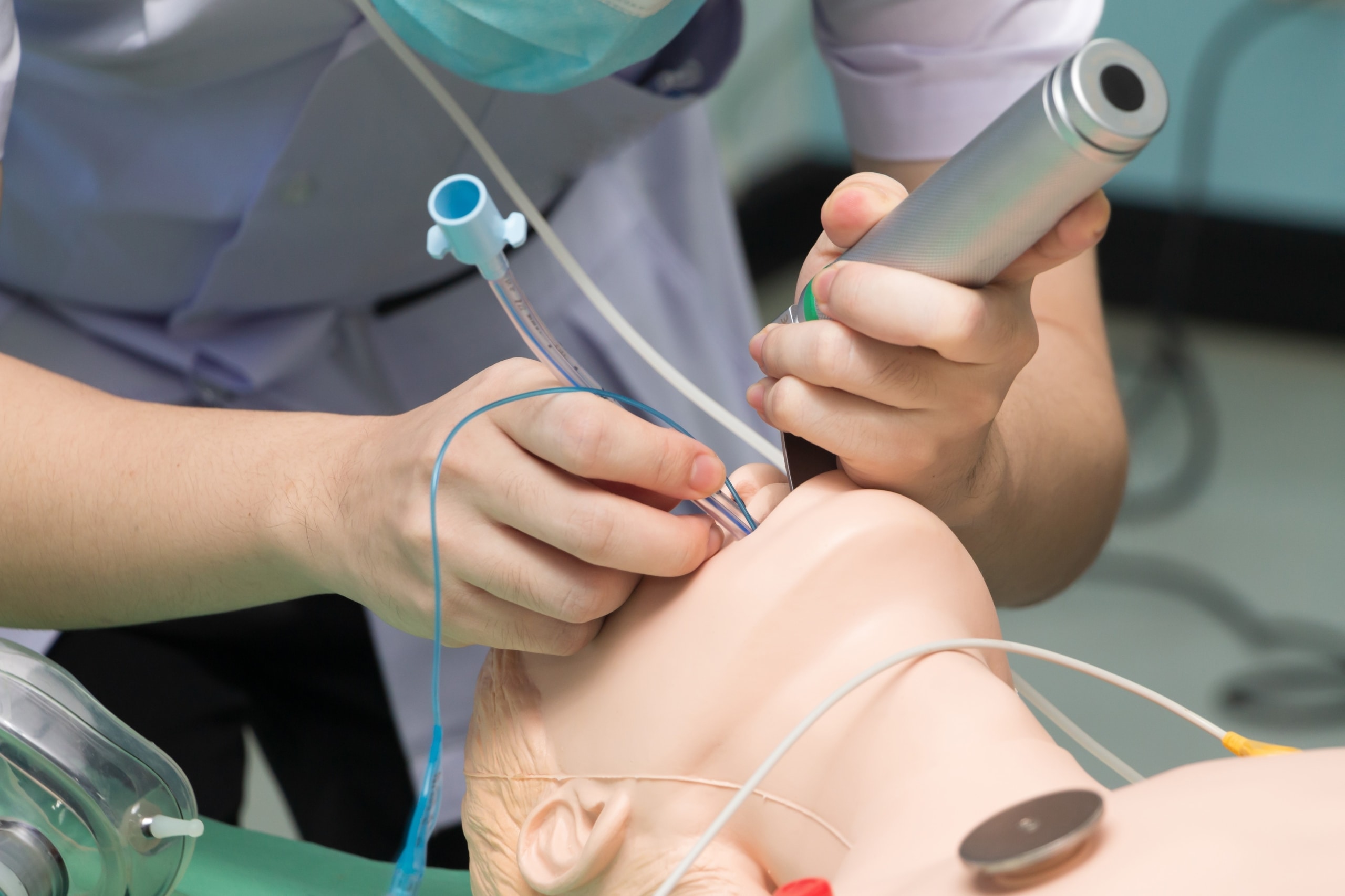 Medical student intubating a mannequin