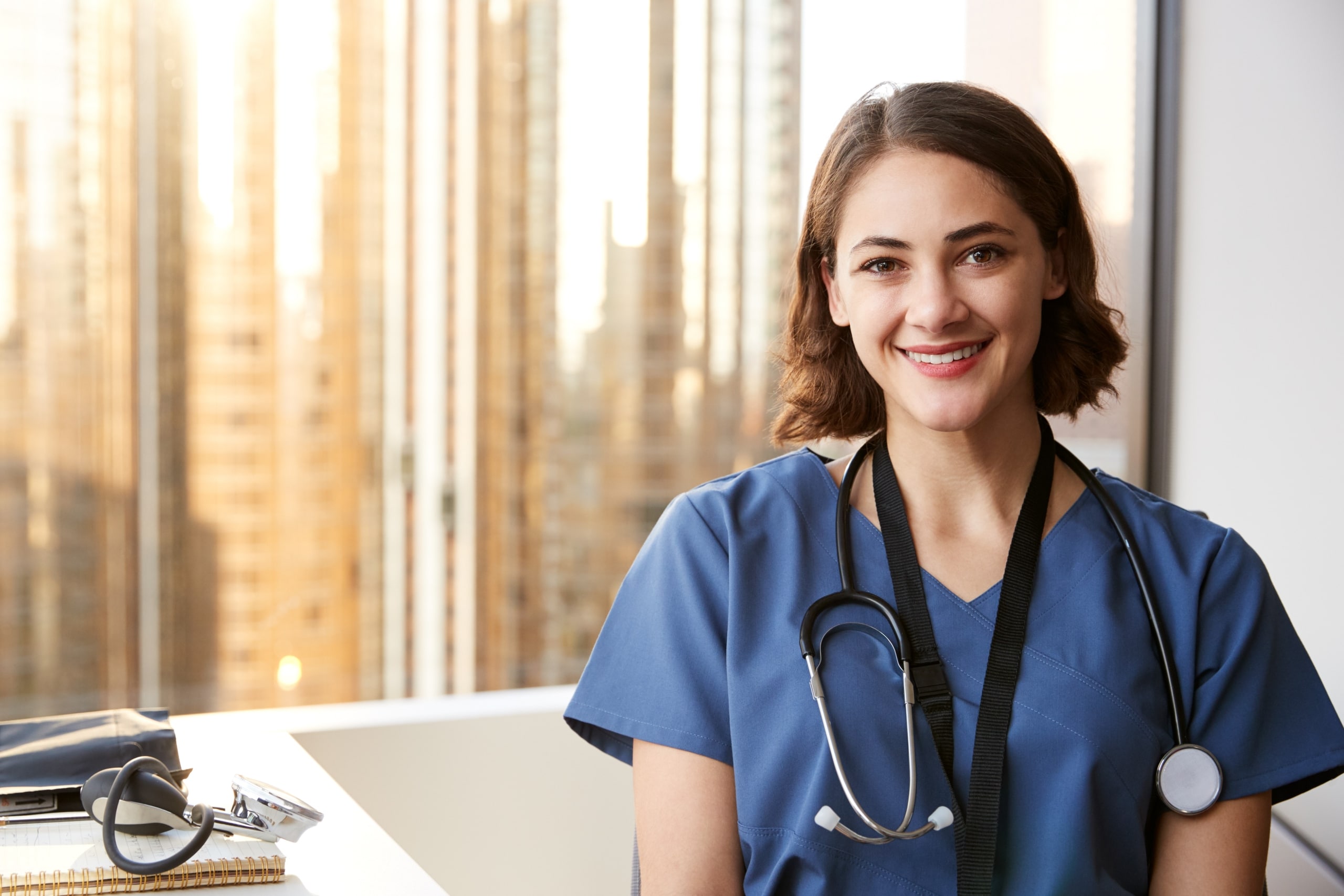 Smiling nurse in an exam room