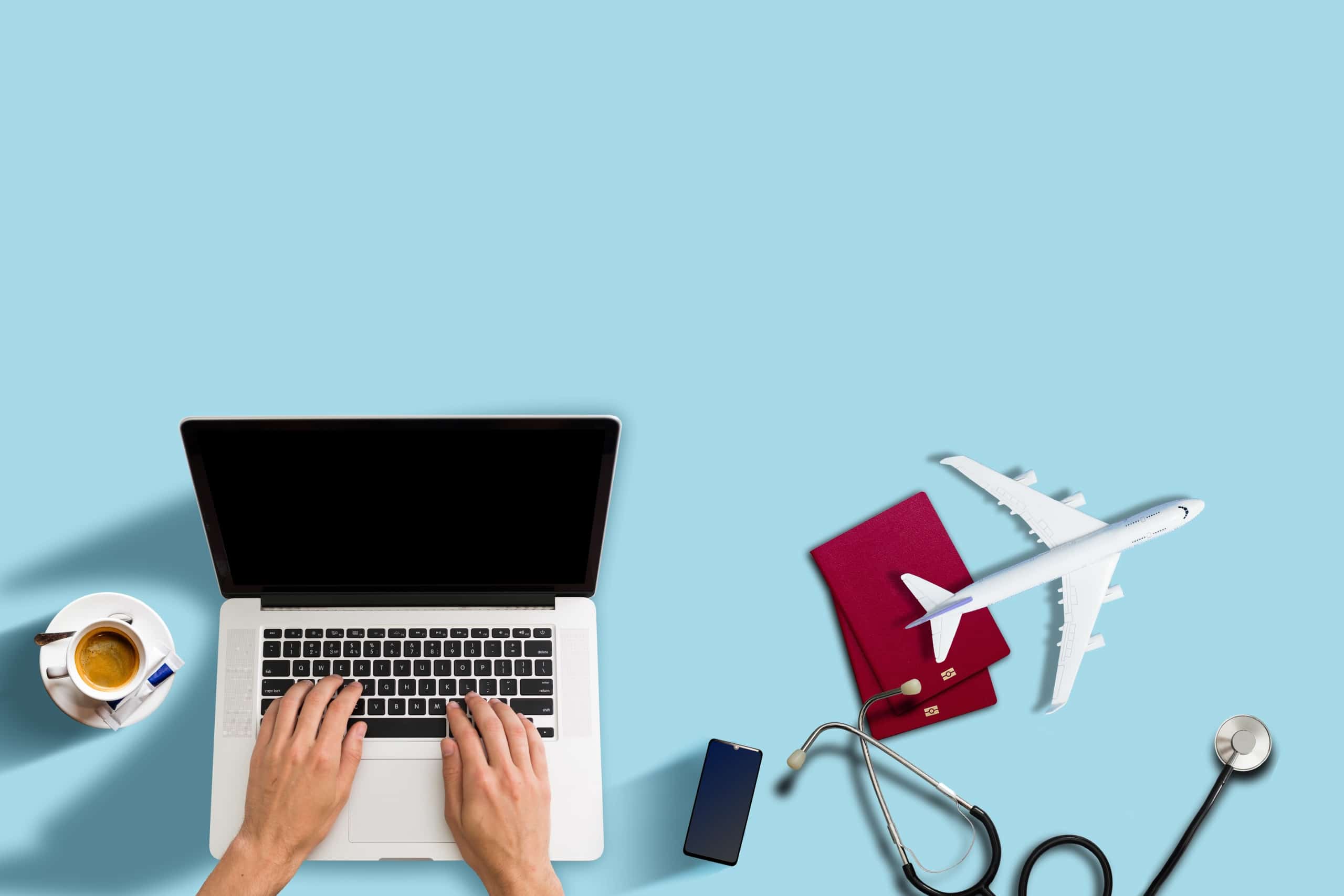 Aerial view of laptop, stethoscope, and replica plane
