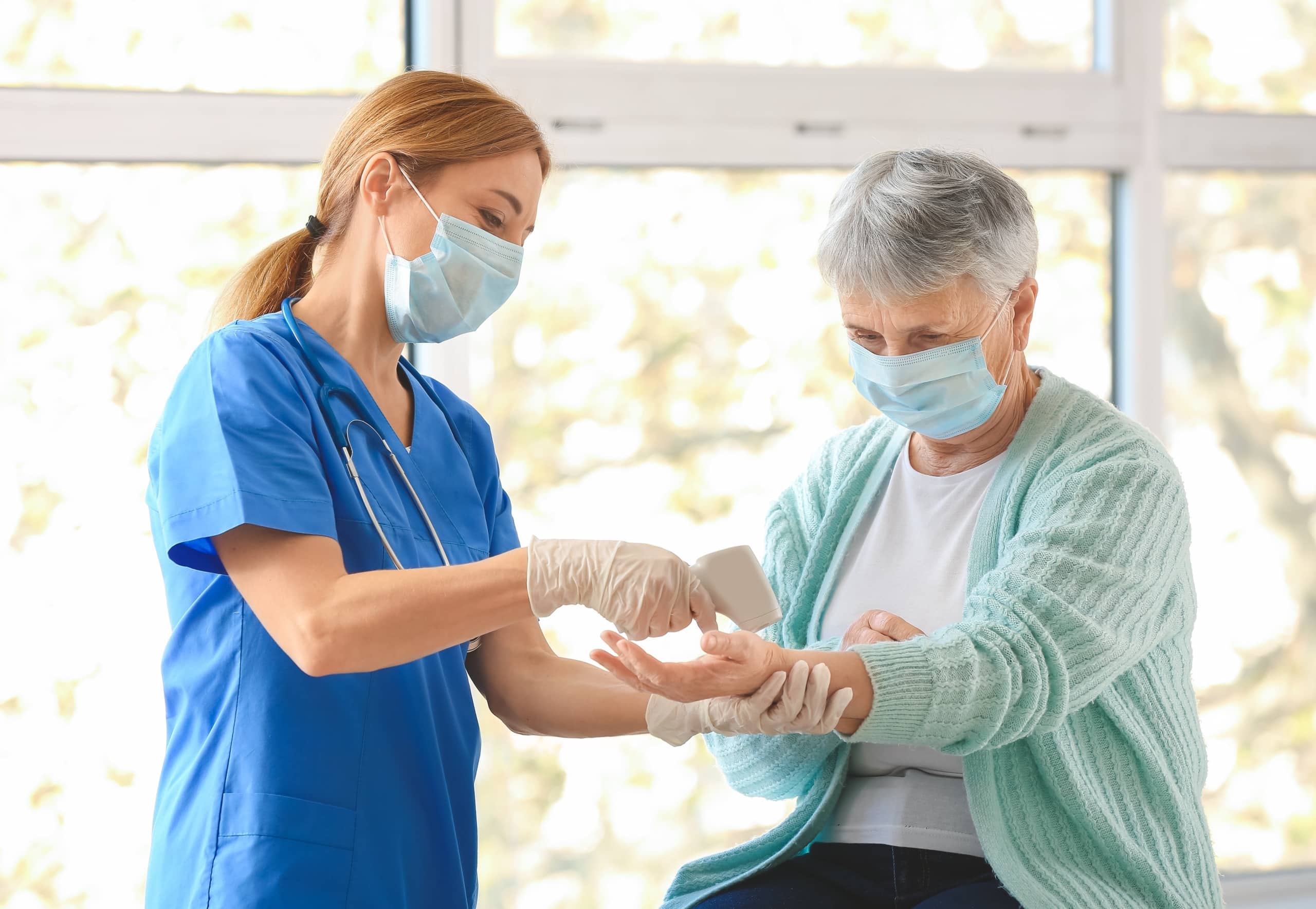 Nurse assisting an elderly patient