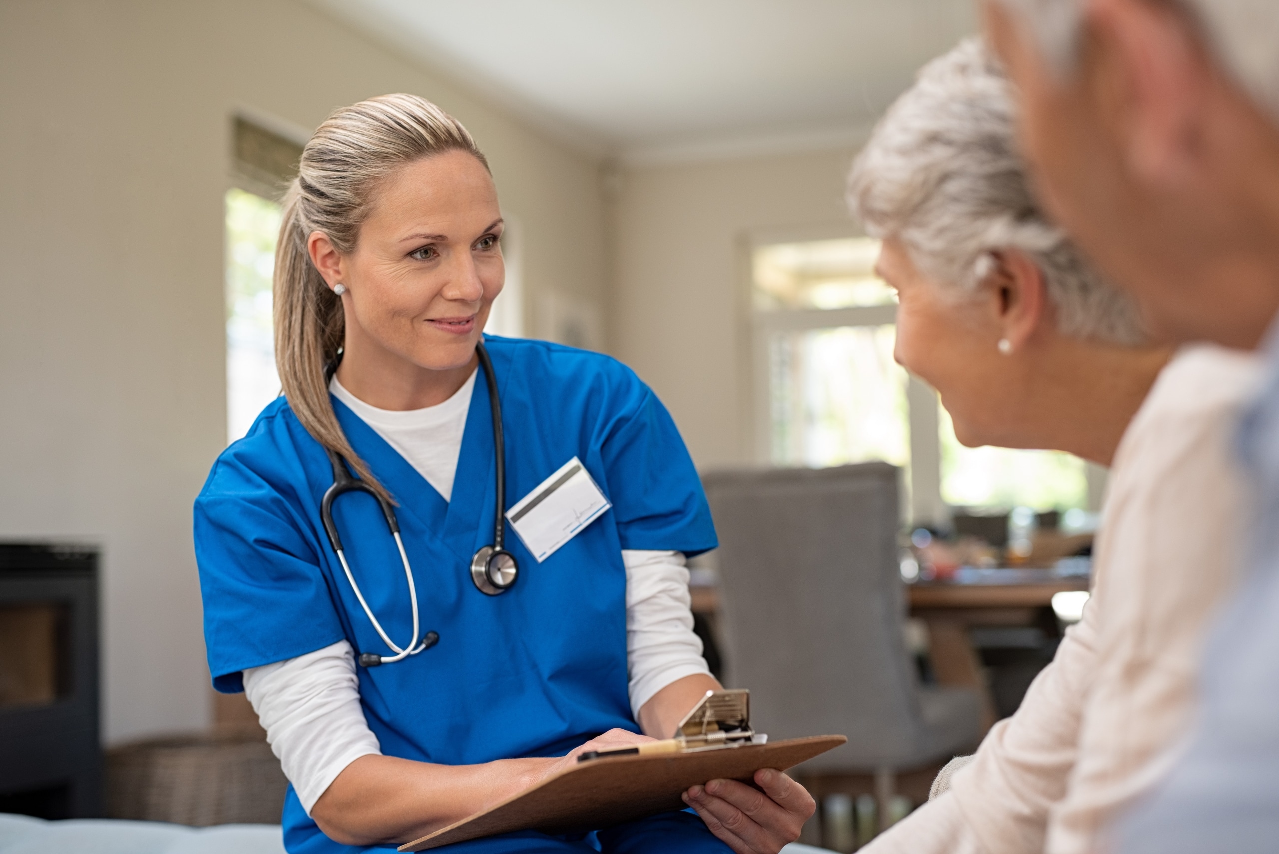Smiling blonde nurse with elderly patient