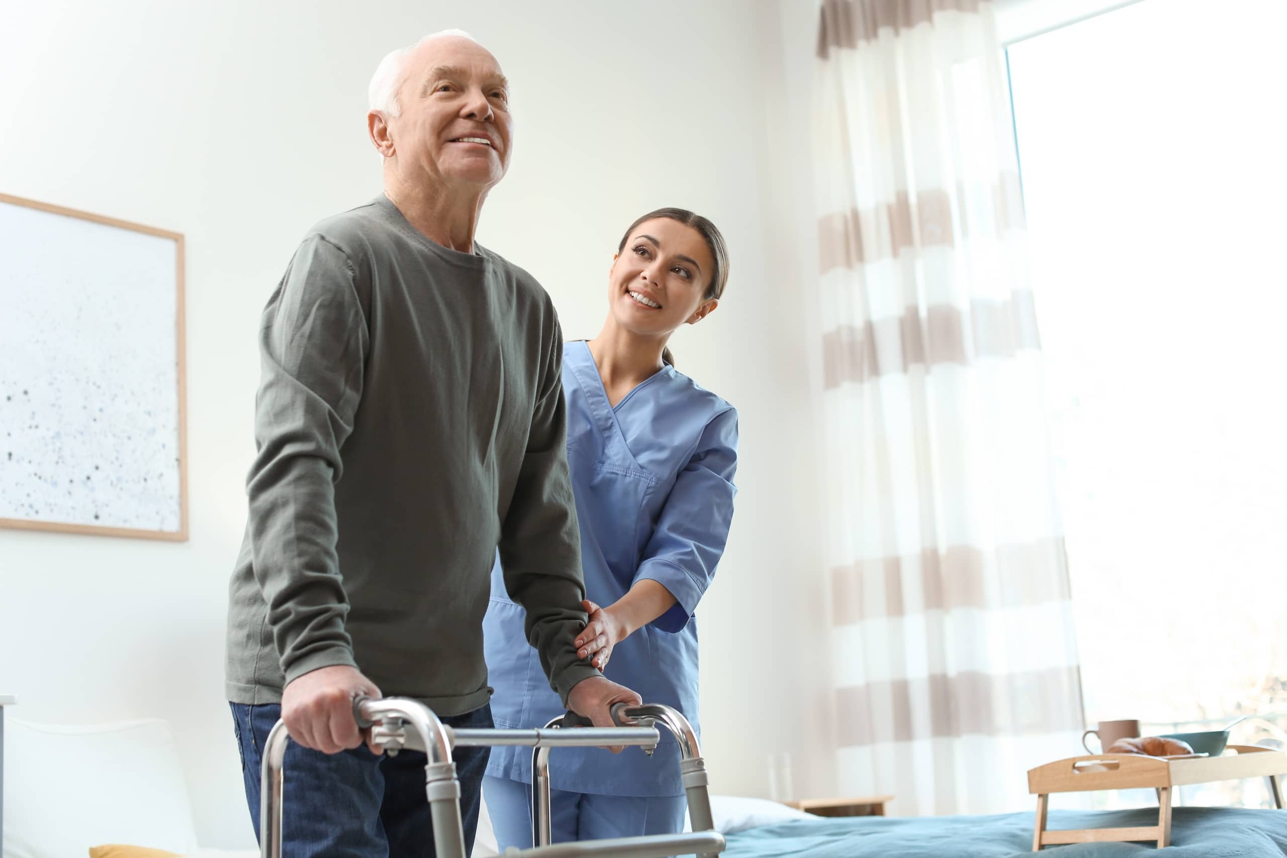 Care worker helping an elderly man