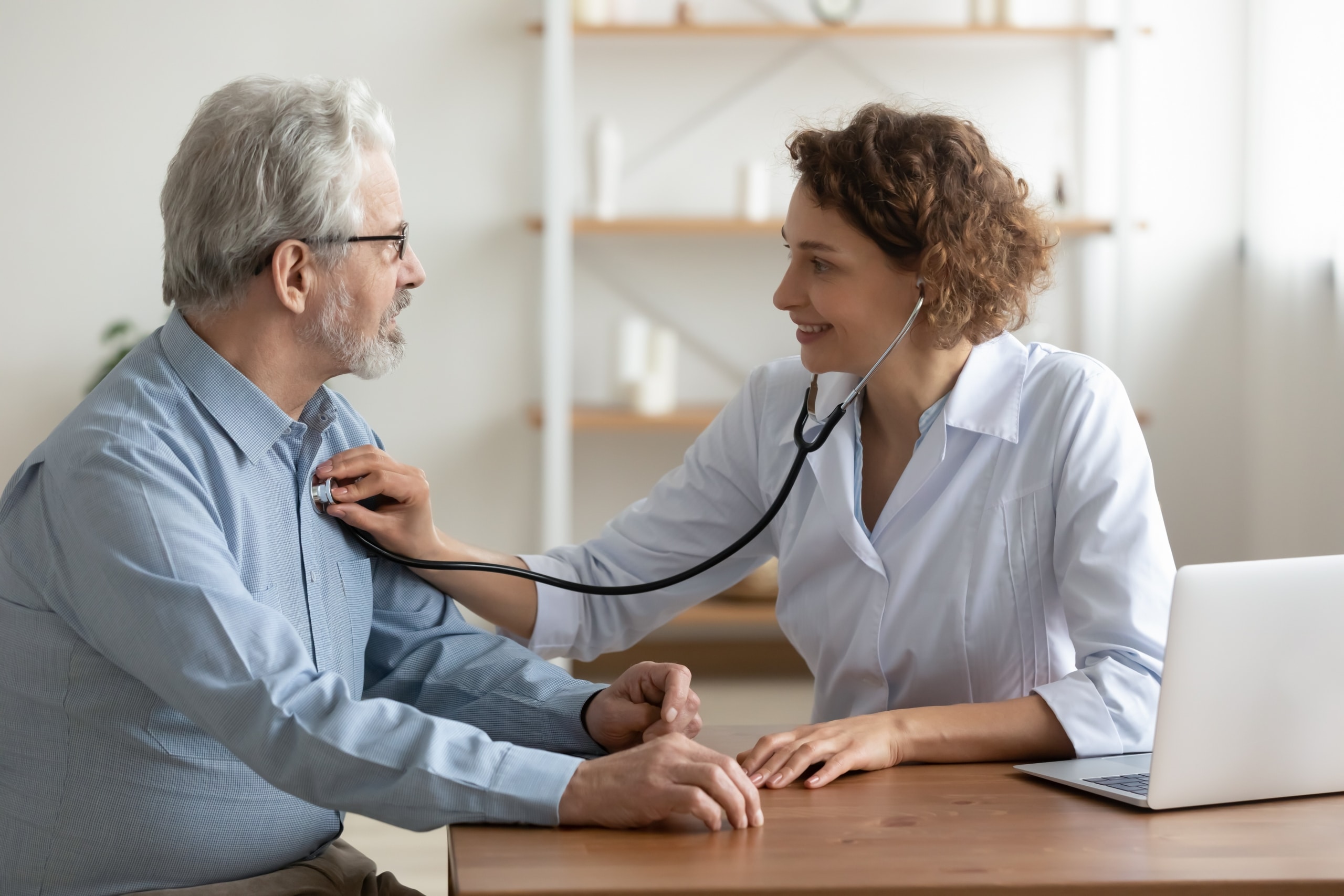 Female nurse measuring a man's heartbeat