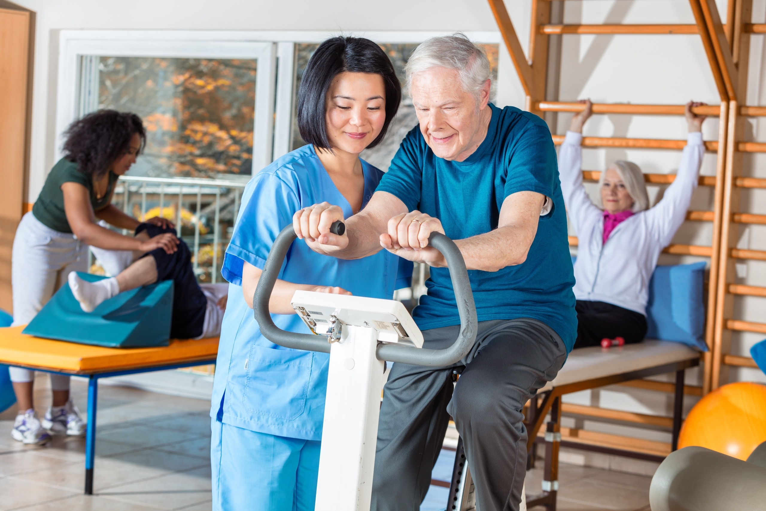 Asian nurse helping an elderly man
