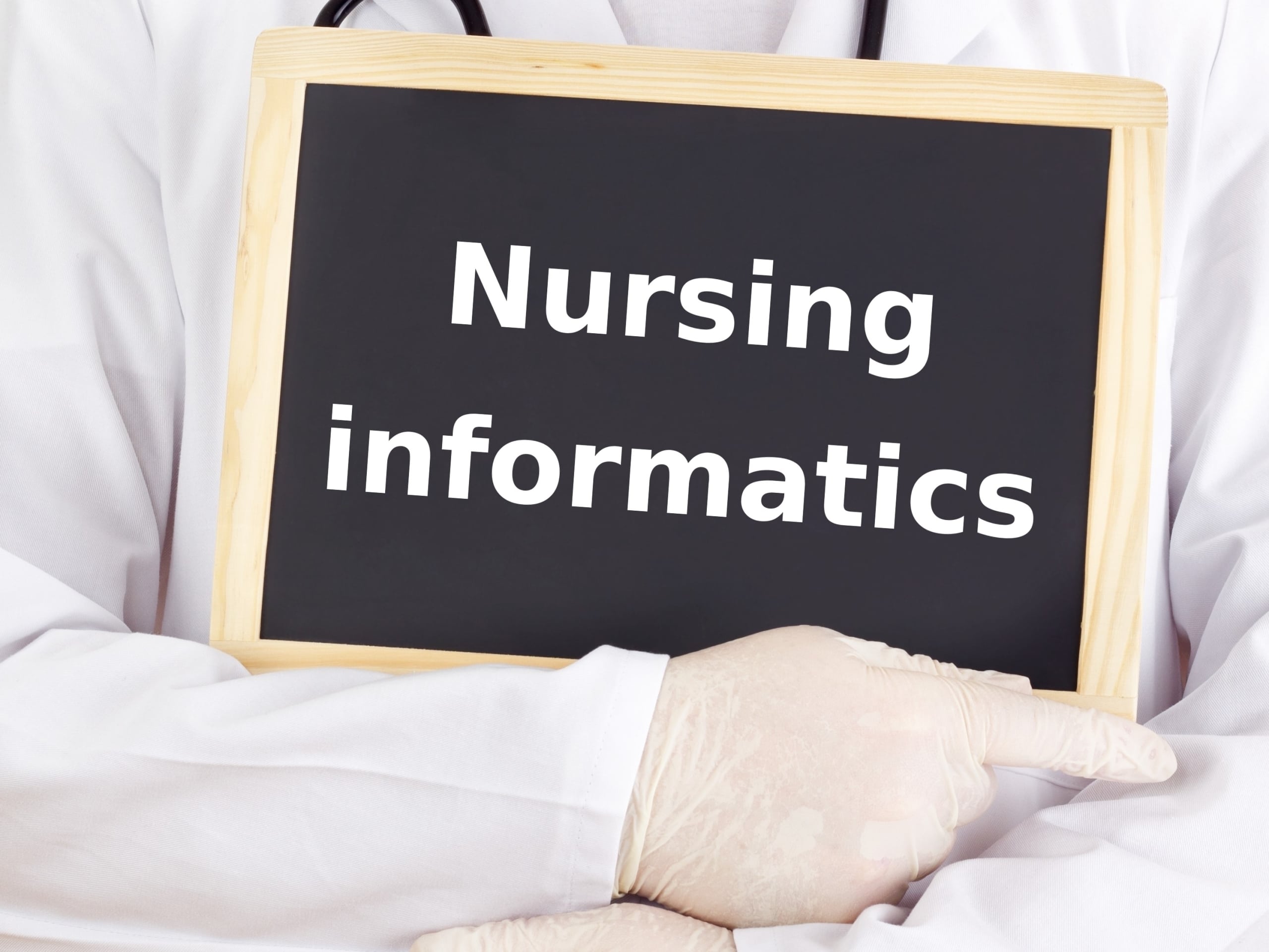 Nurse holding a sign that says nursing informatics