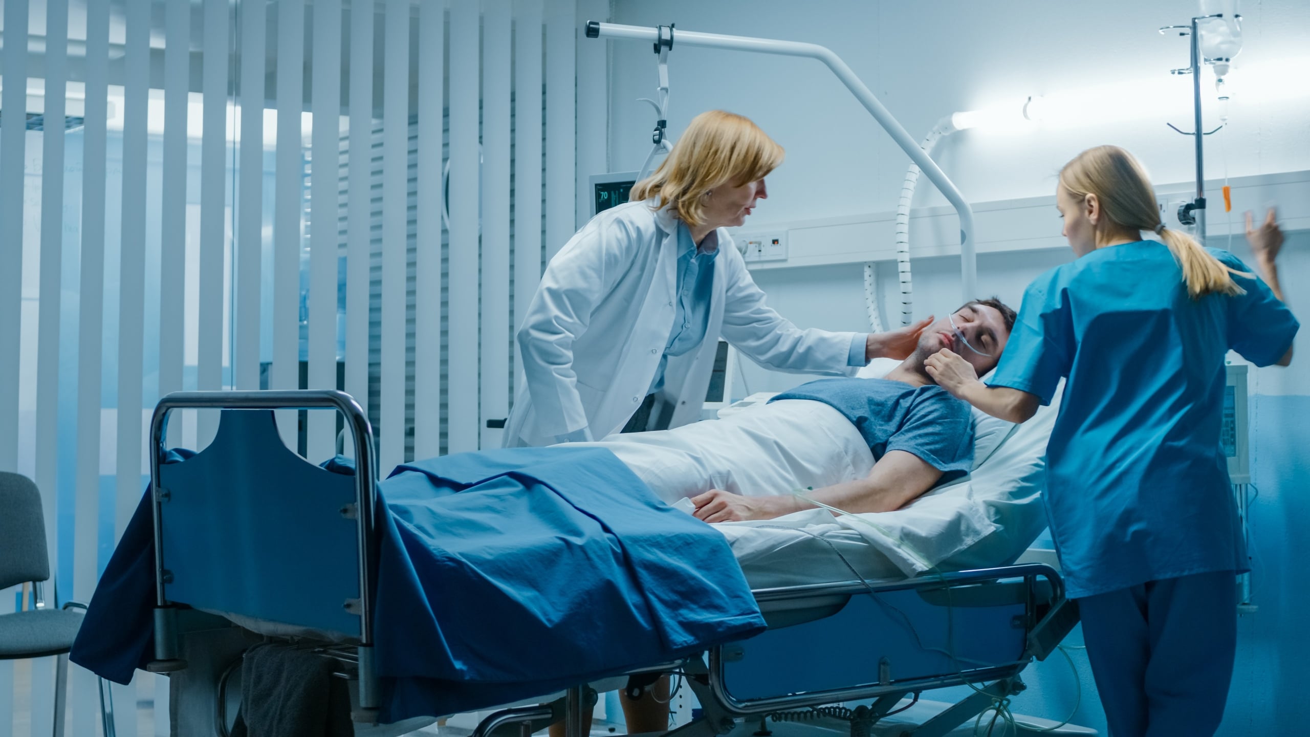 Medical professionals helping an ICU patient