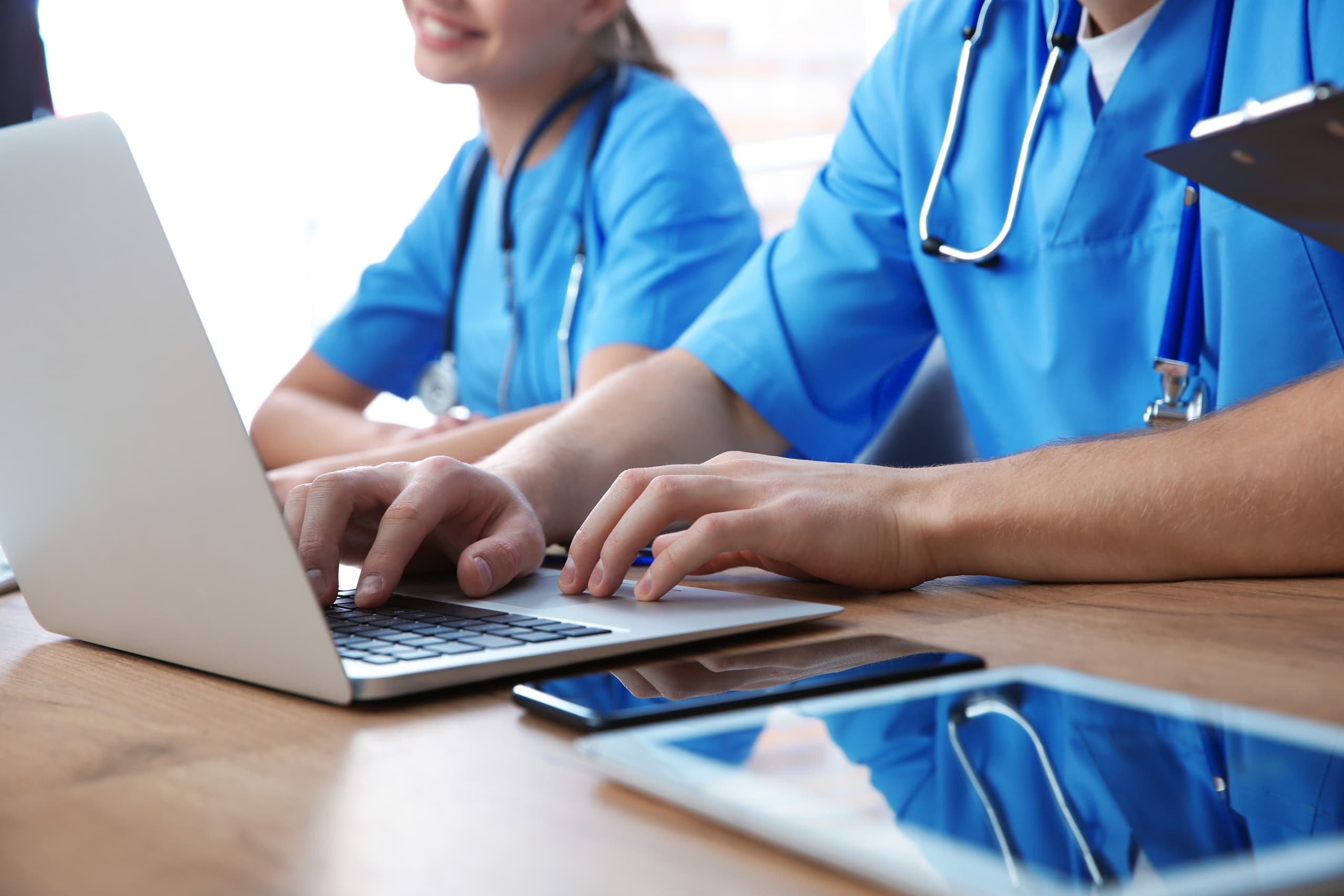 Close up of medical students studying on laptops