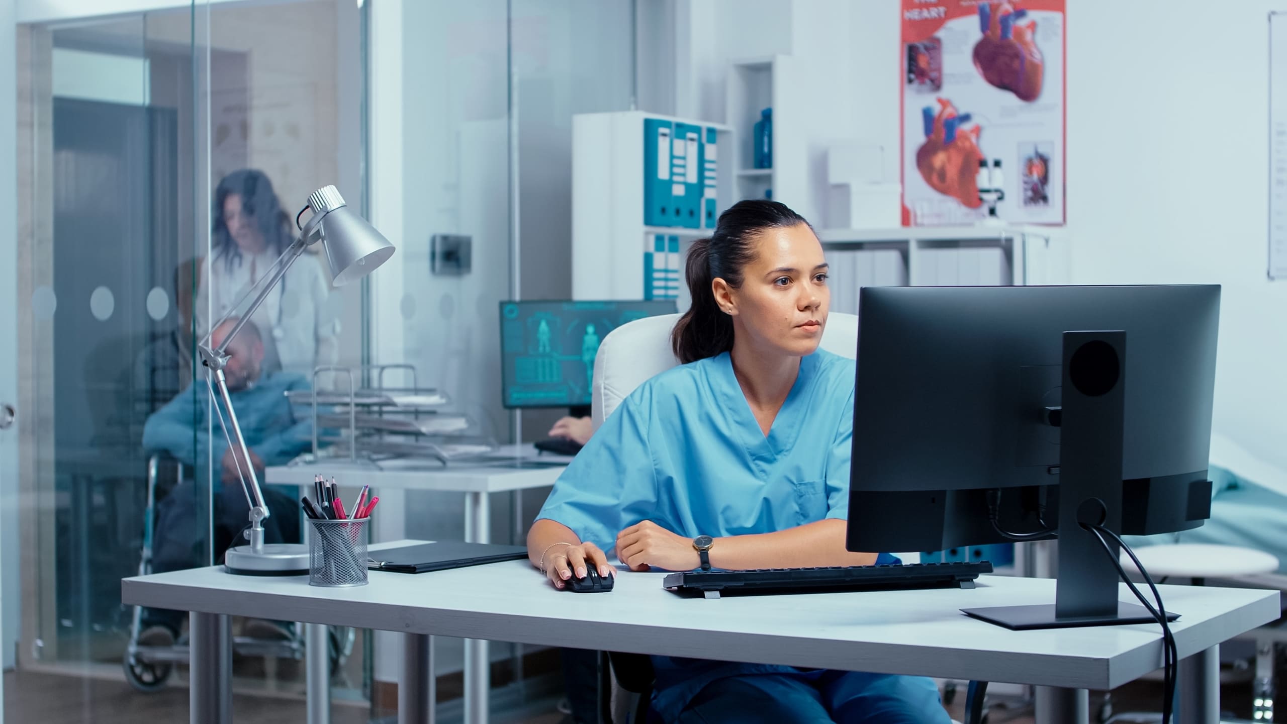 Medical professional concentrating while using a computer