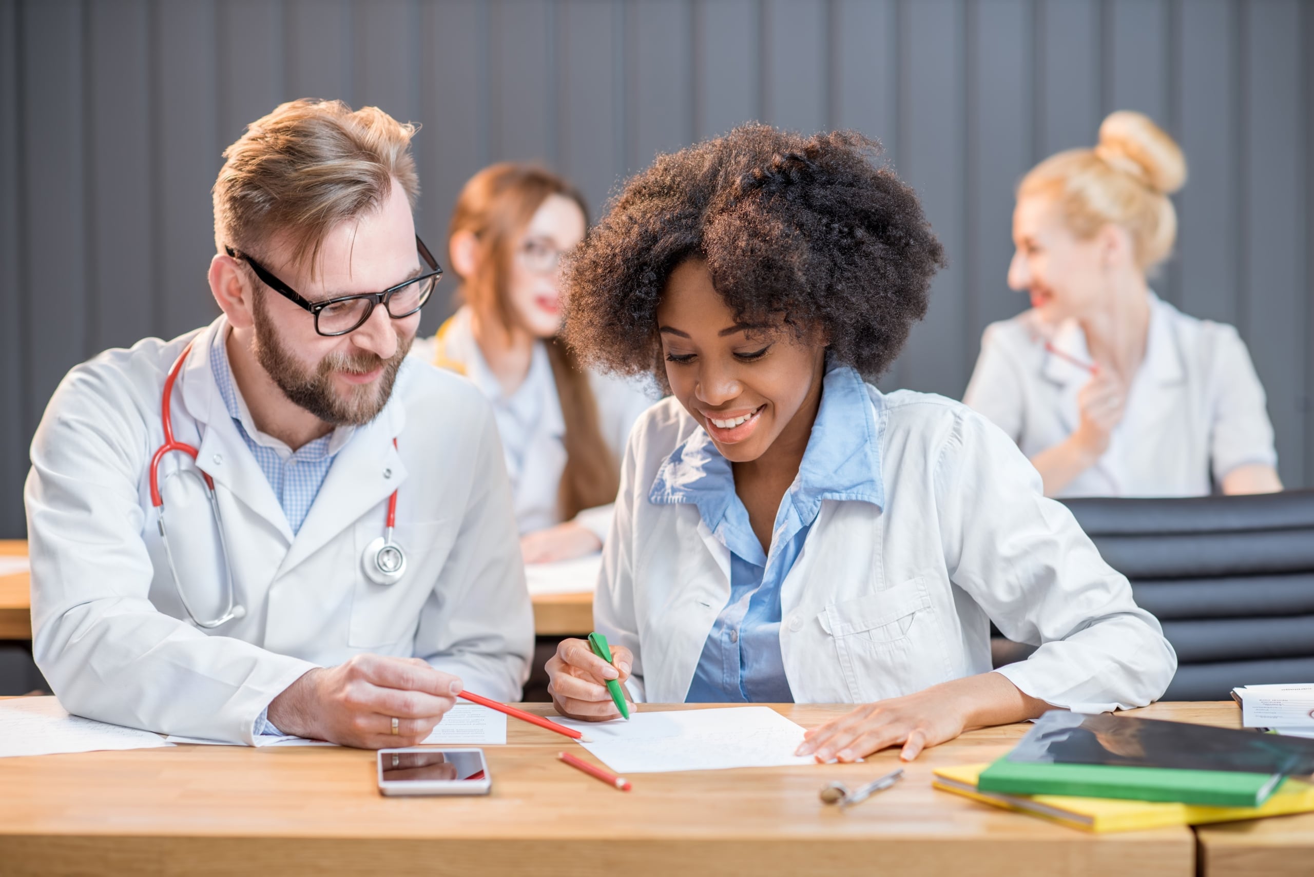 Medical students looking at a book together