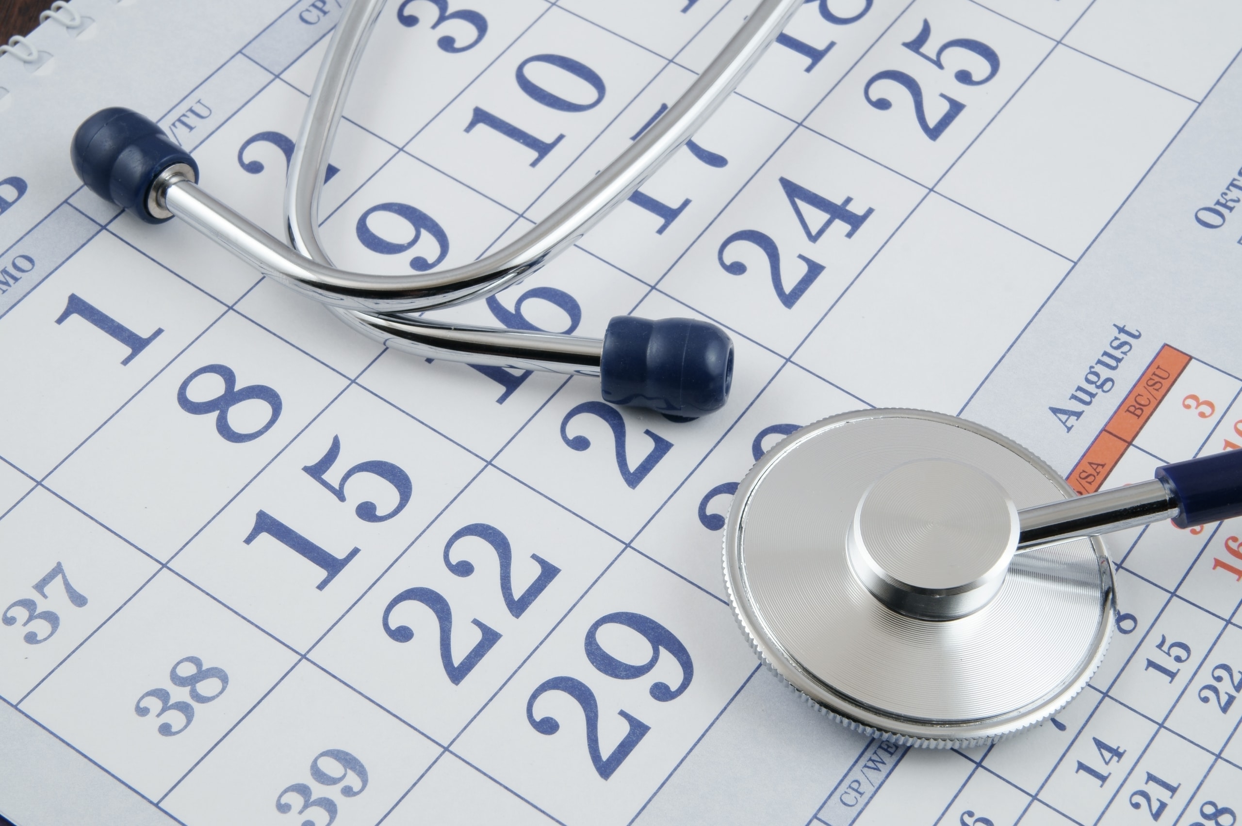 Close up of a stethoscope and a calendar