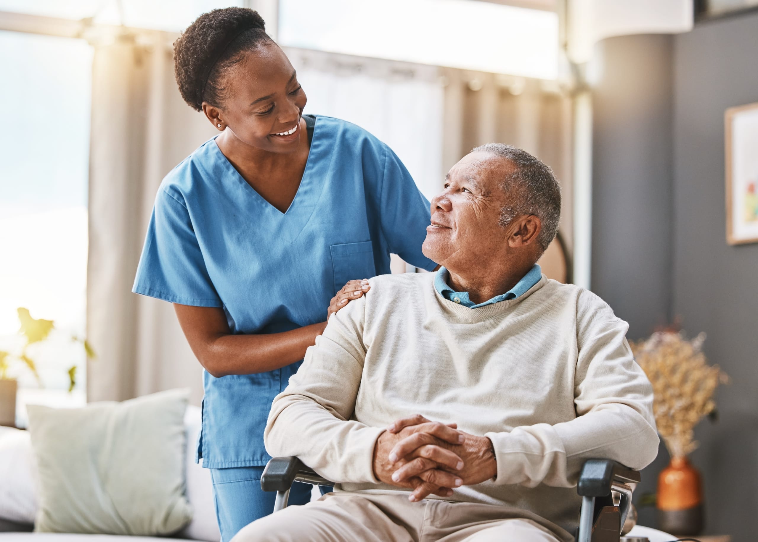 African-American medical professional with a patient in a wheelchair