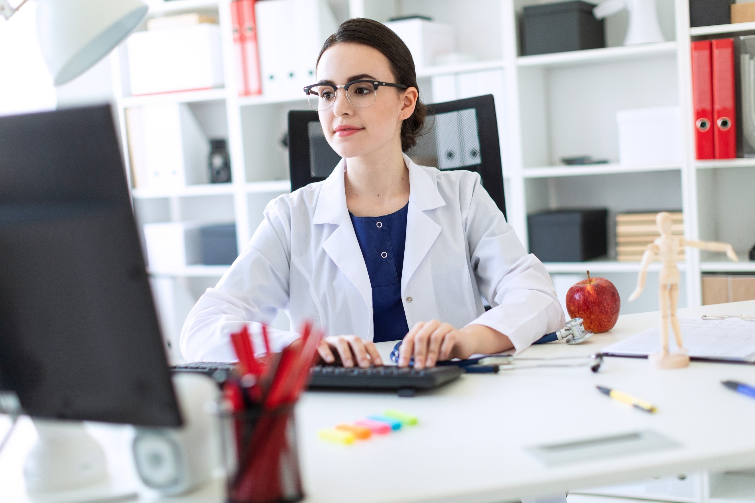Young medical professional using a laptop