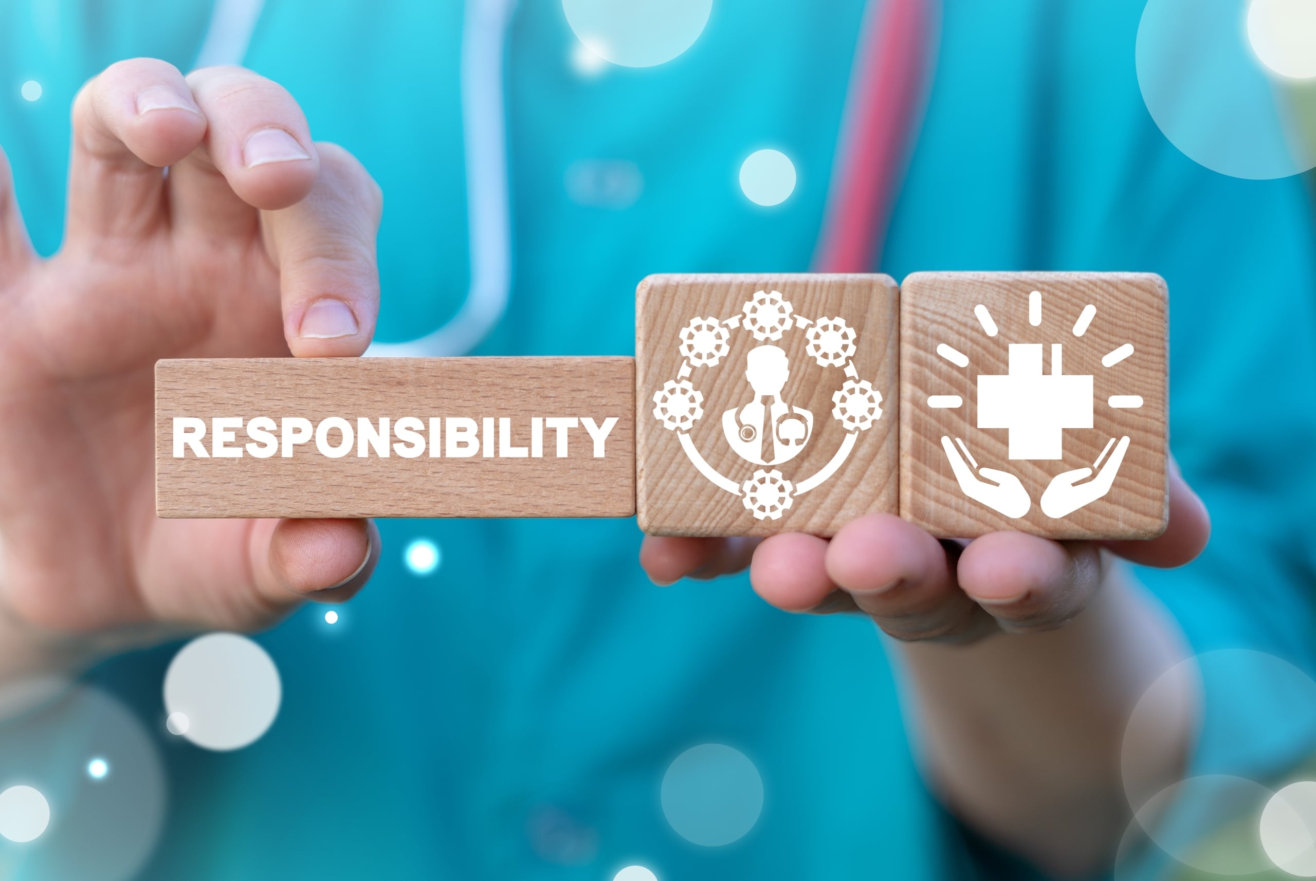 Close up of a nurse holding blocks with healthcare symbols for ethics