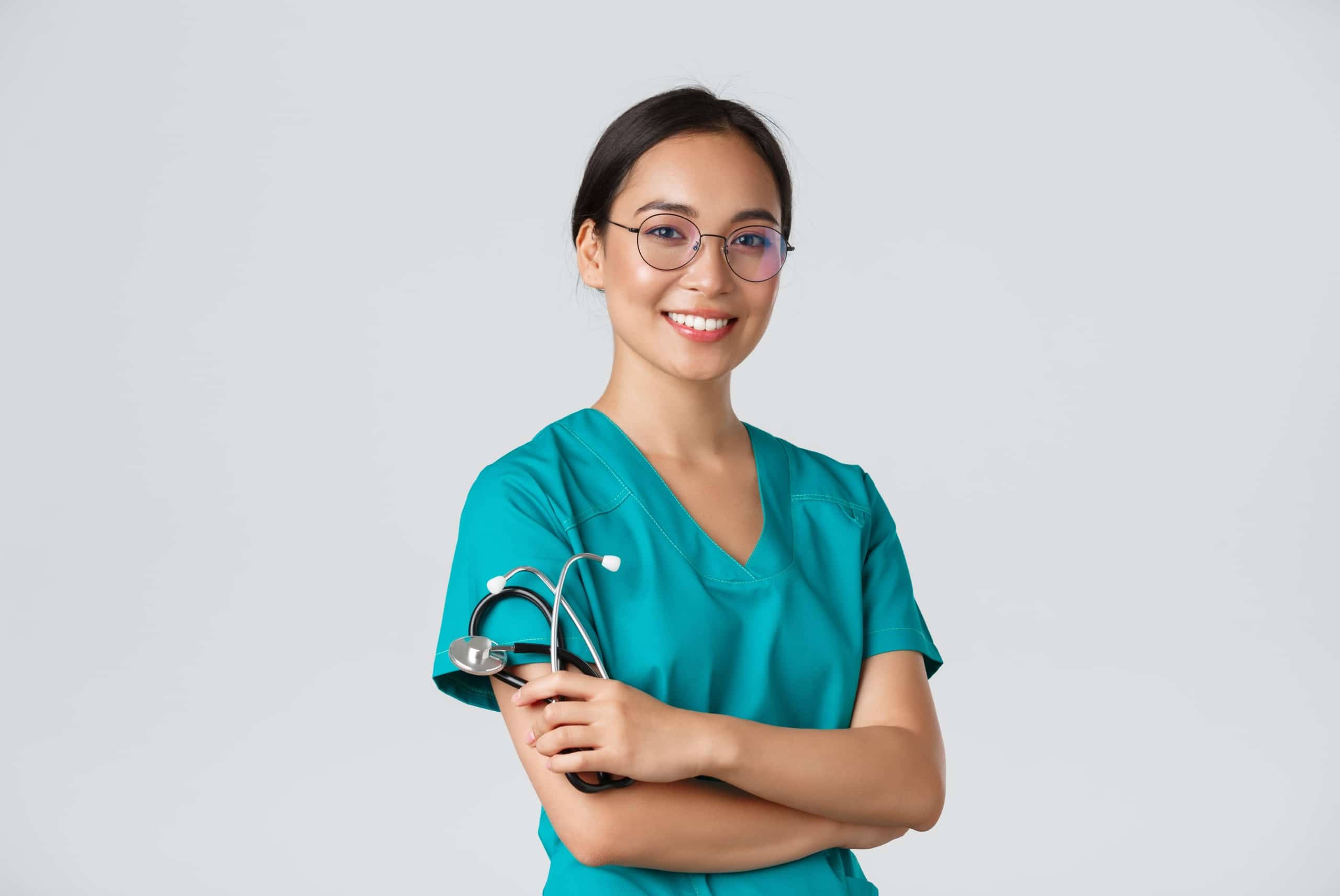 Smiling Asian nurse wearing glasses and holding a stethoscope