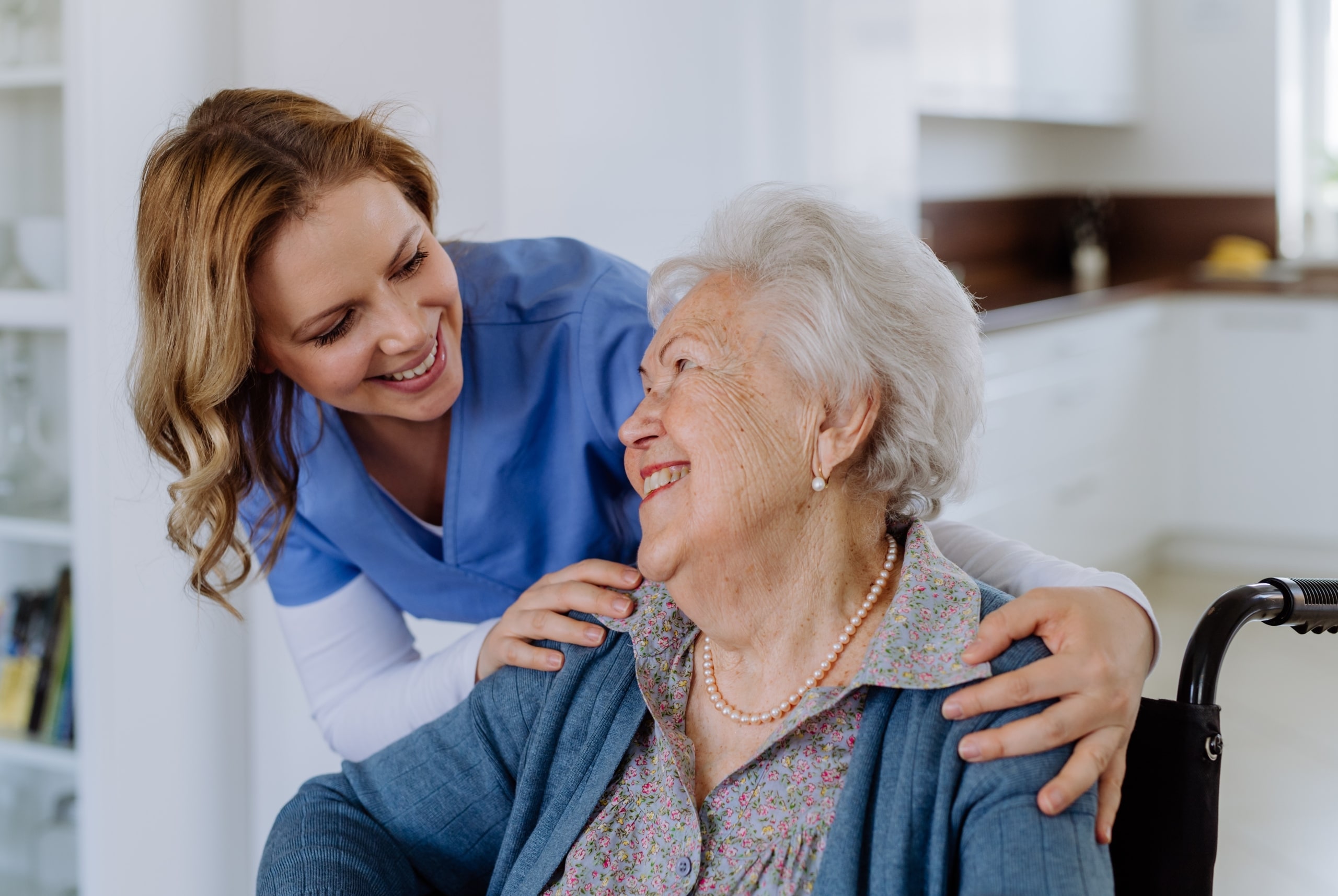 Female nurse smiling at an elderly woman