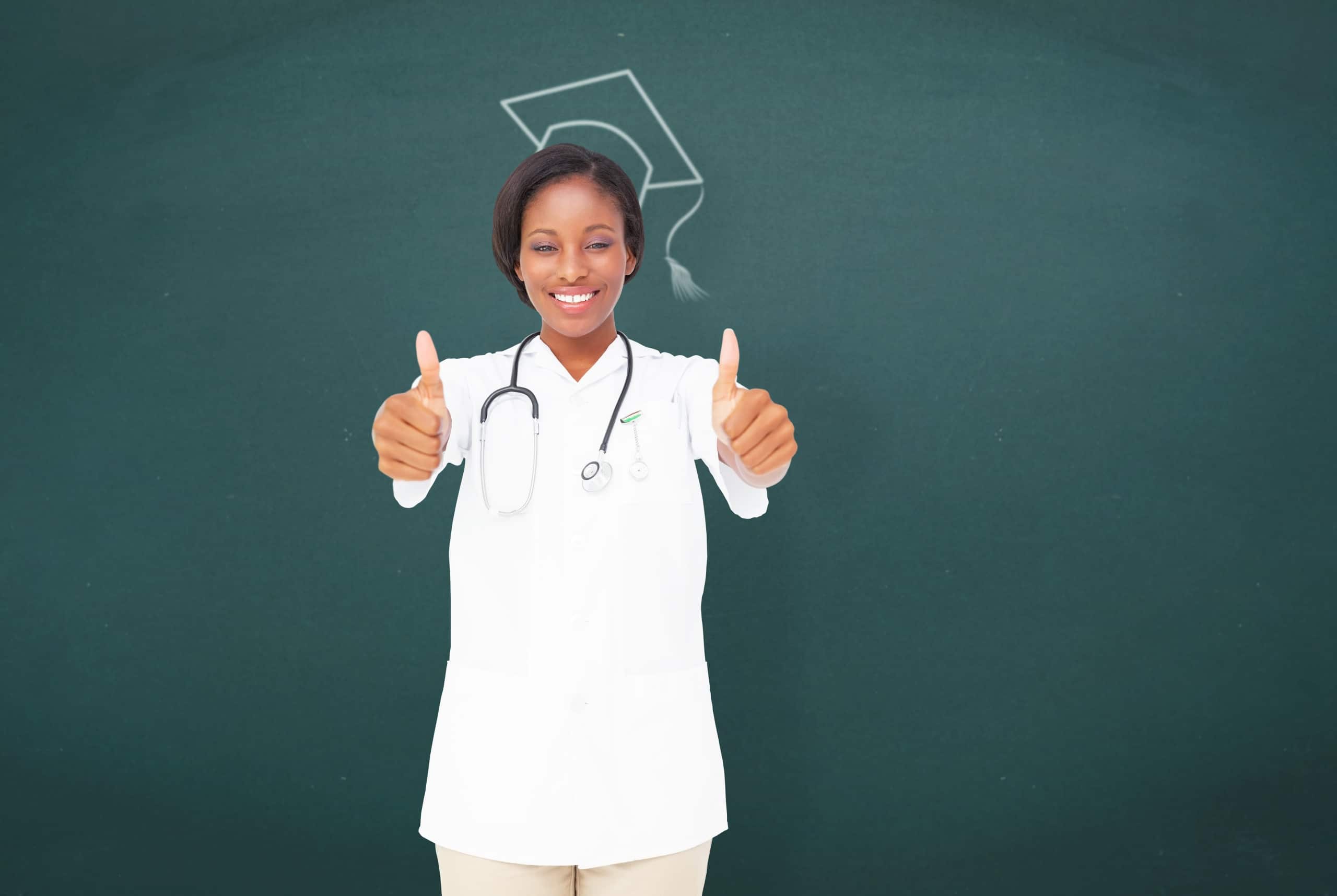 Nurse against a dark backdrop with a chalk drawing of a graduation cap