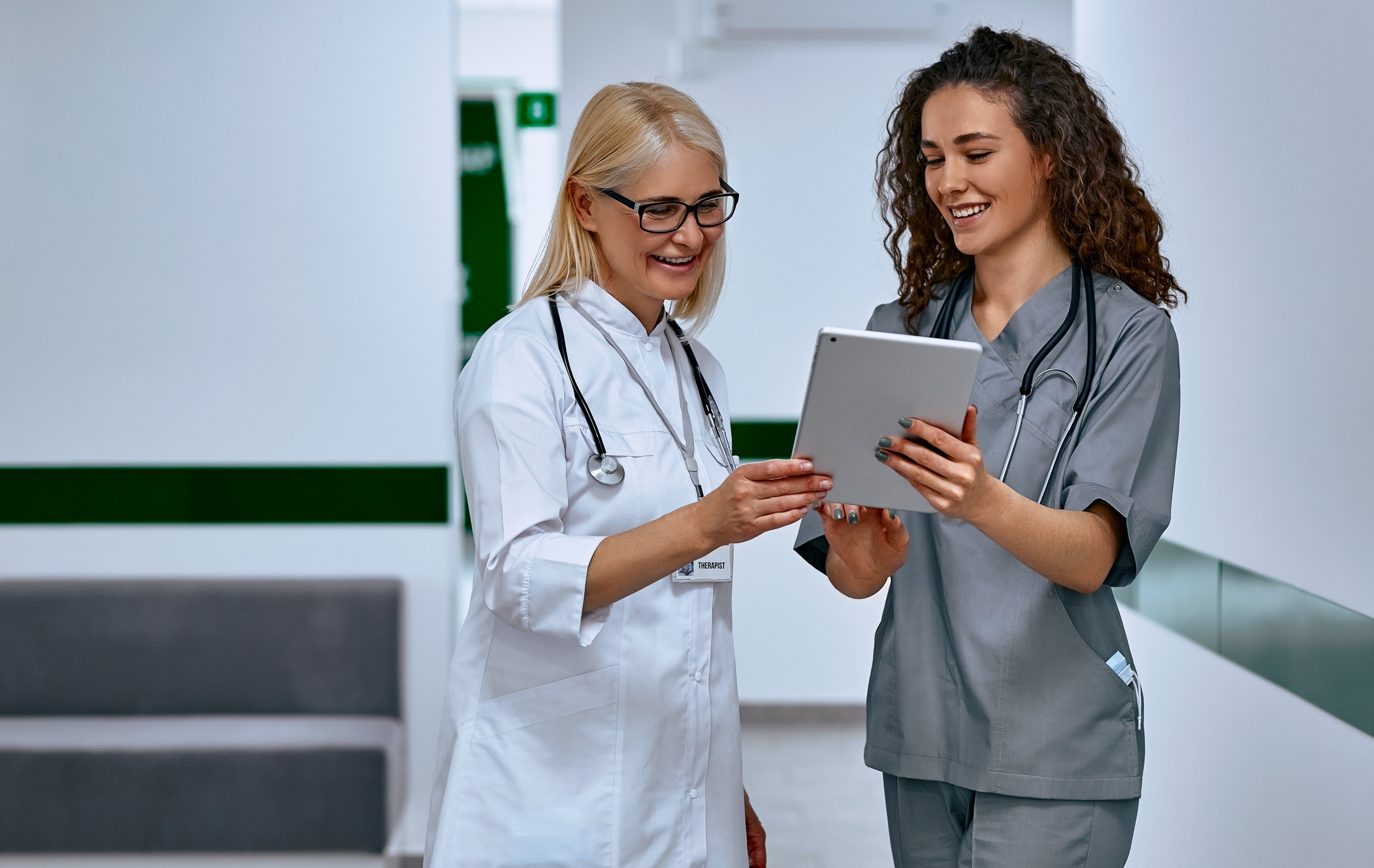 Female doctor with a medical assistant looking at paperwork