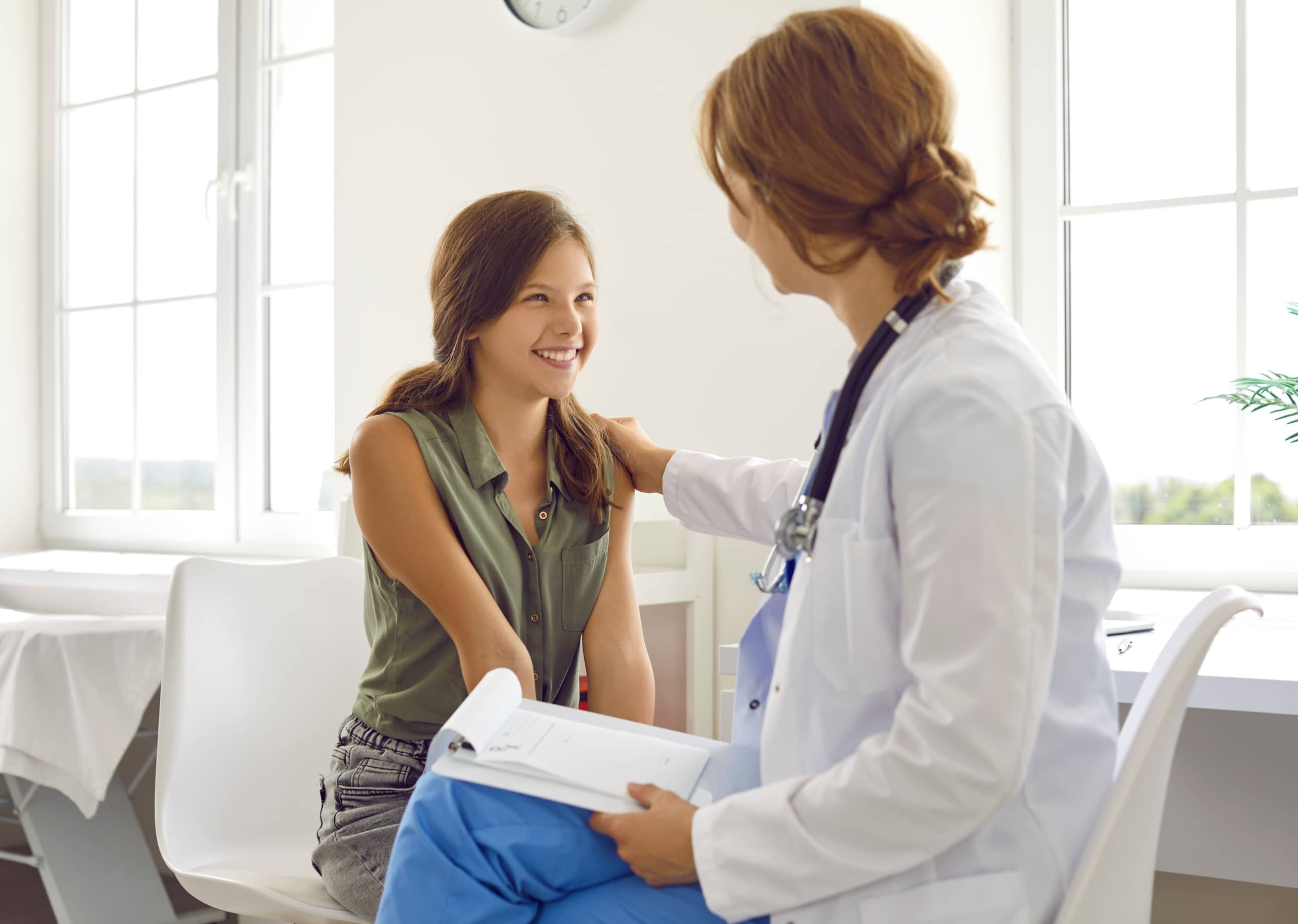 School nurse speaking with a smiling female student
