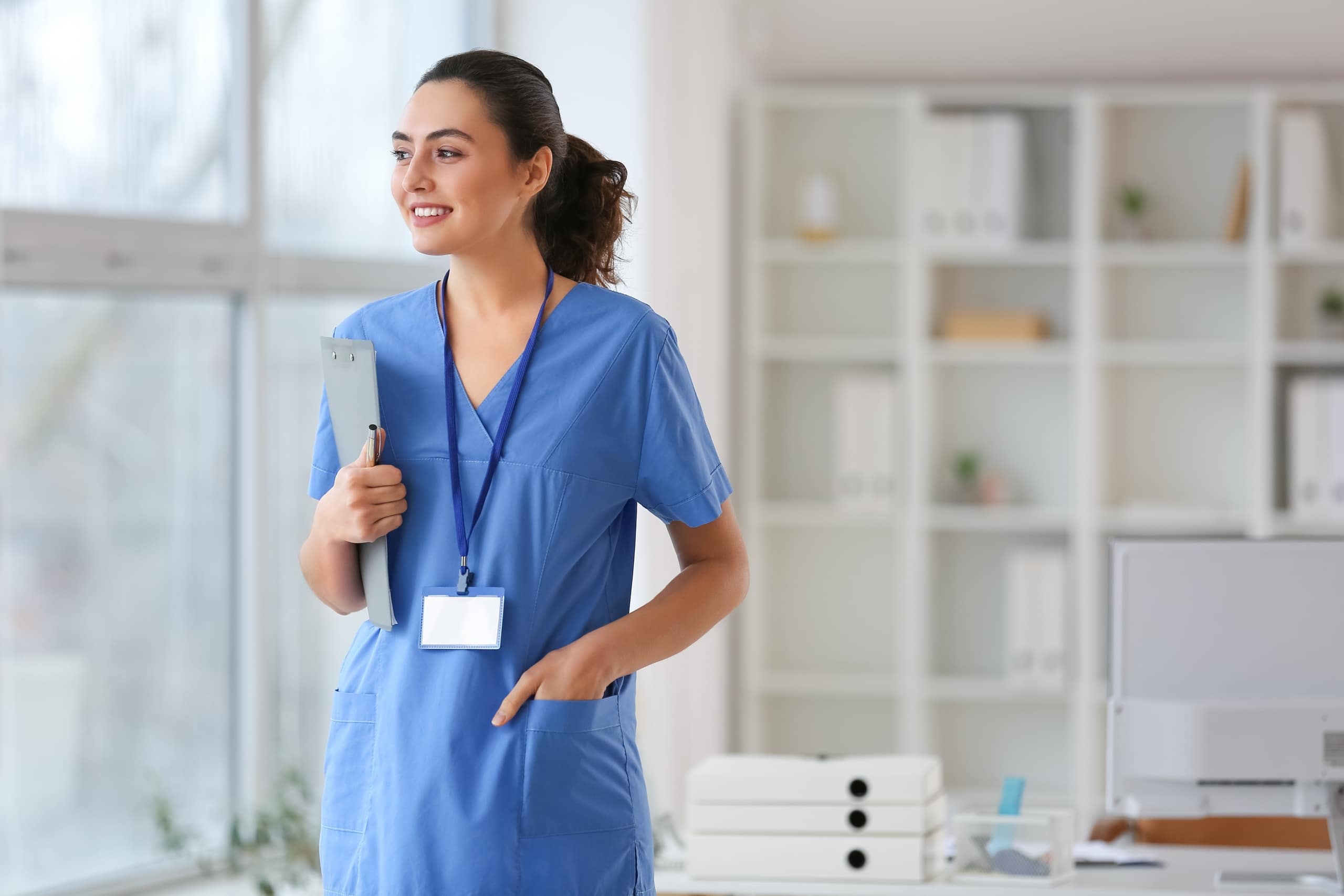 Medical professional smiling and looking out a window