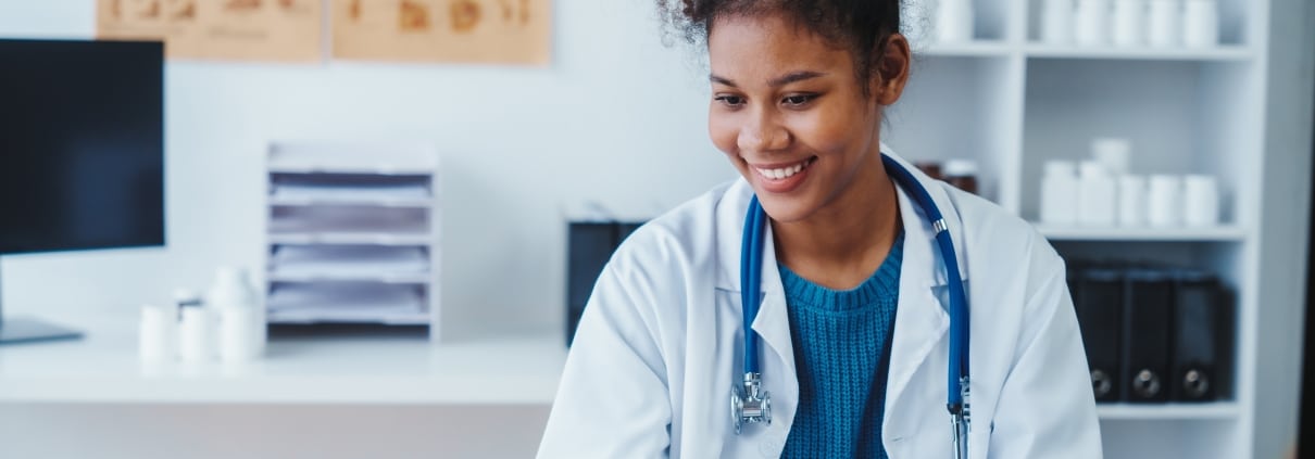 Smiling African-American medical professional at a desk