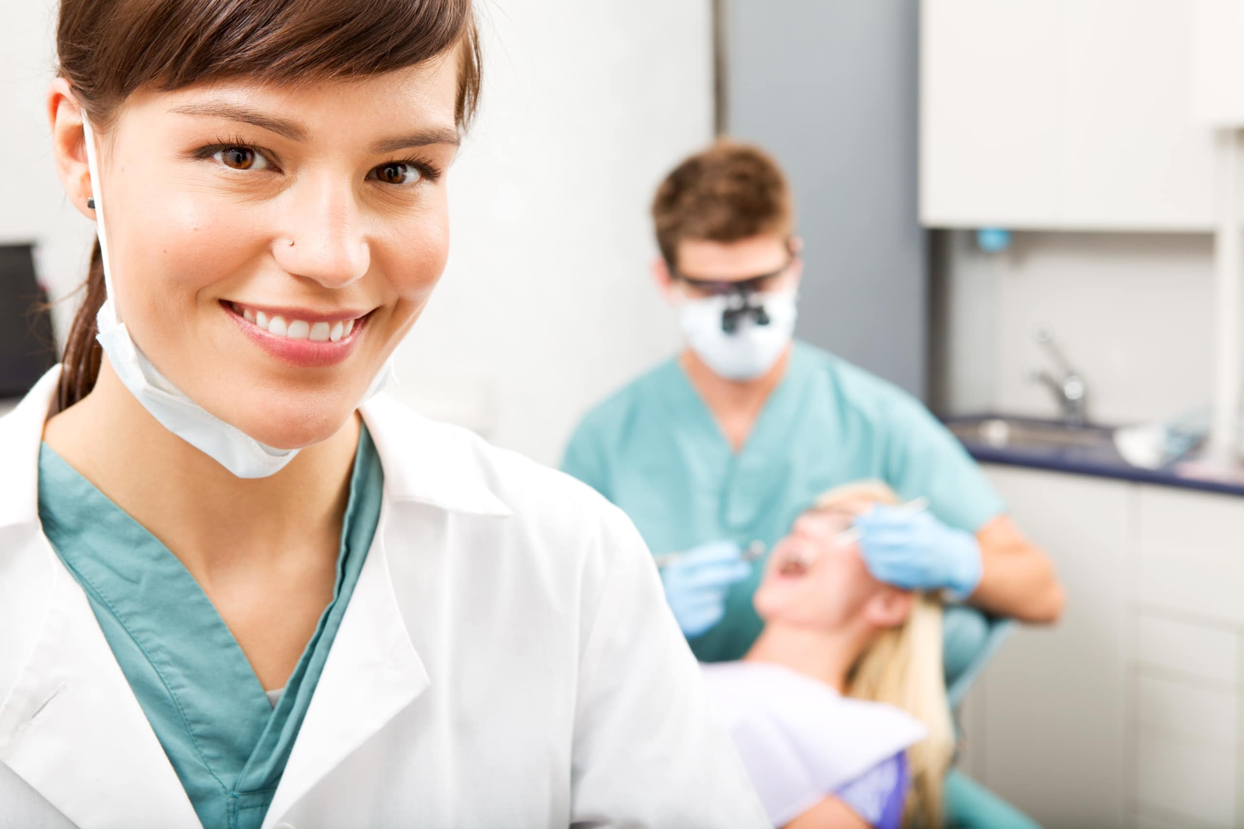 Dental team with a patient in an exam room