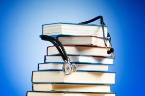 Stack of books with a stethoscope draped on top