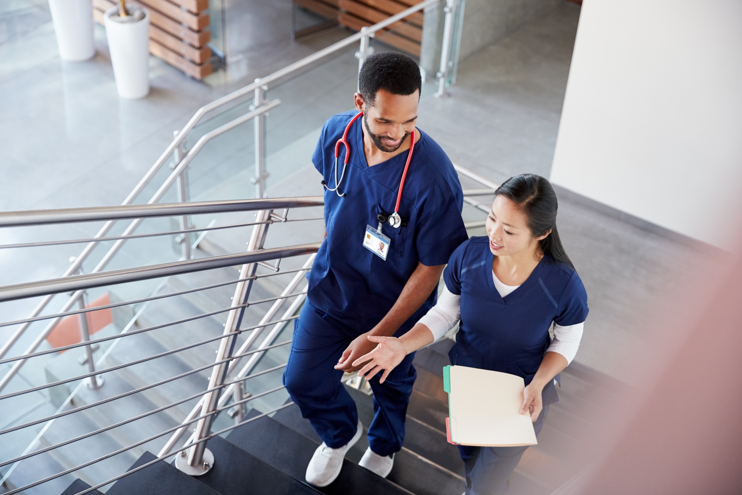 Two nurses ascending a staircase