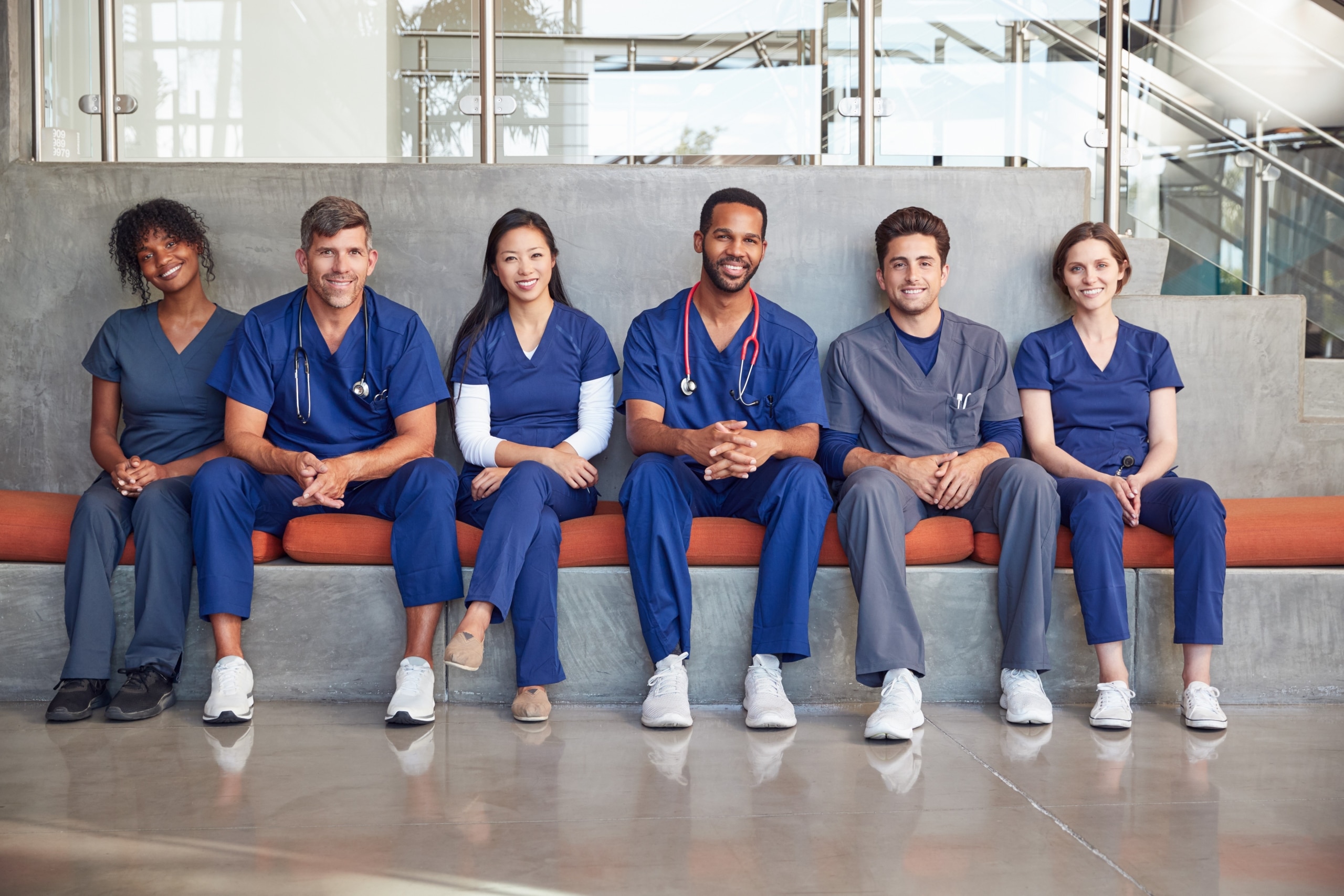 Group of medical professionals sitting on a bench