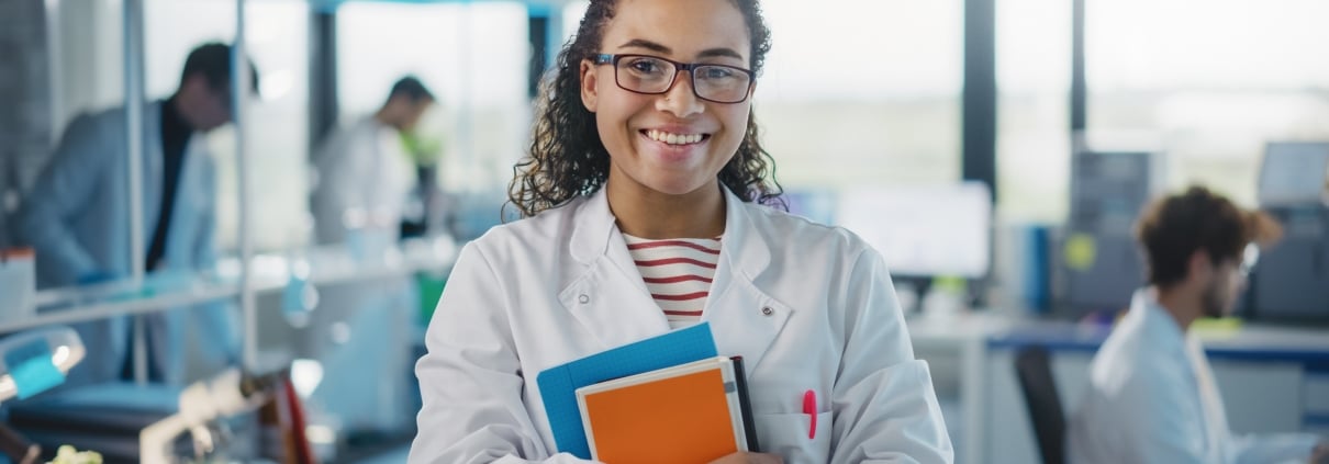 Medical student with glasses standing in a computer lab