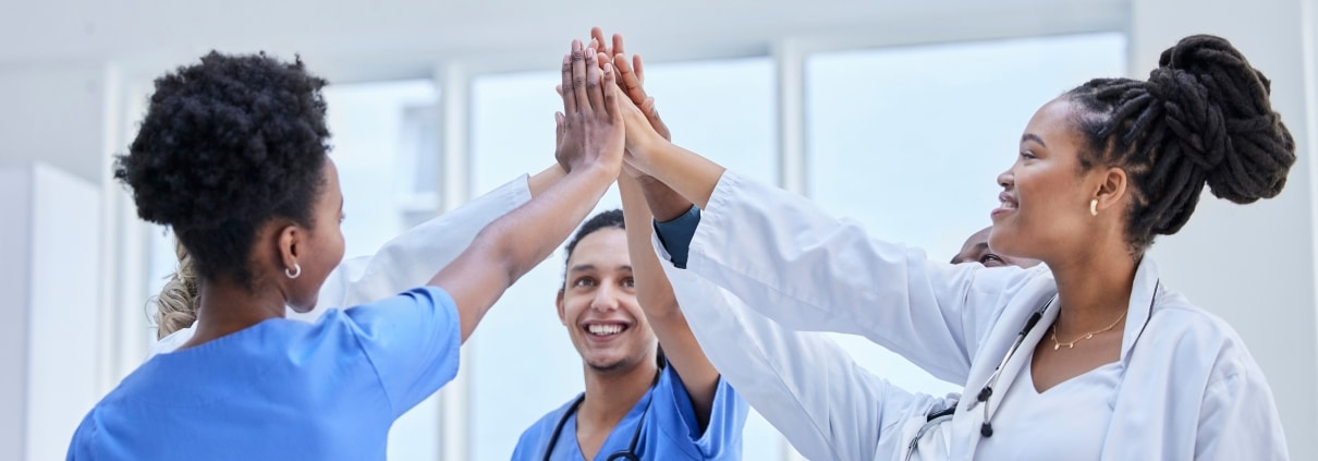 Group of female nurses high fiving each other