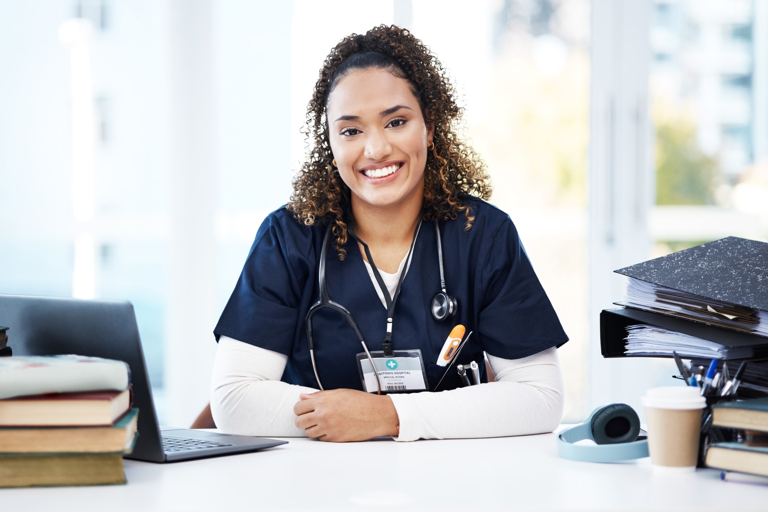 African-American medical professional smiling at a desk