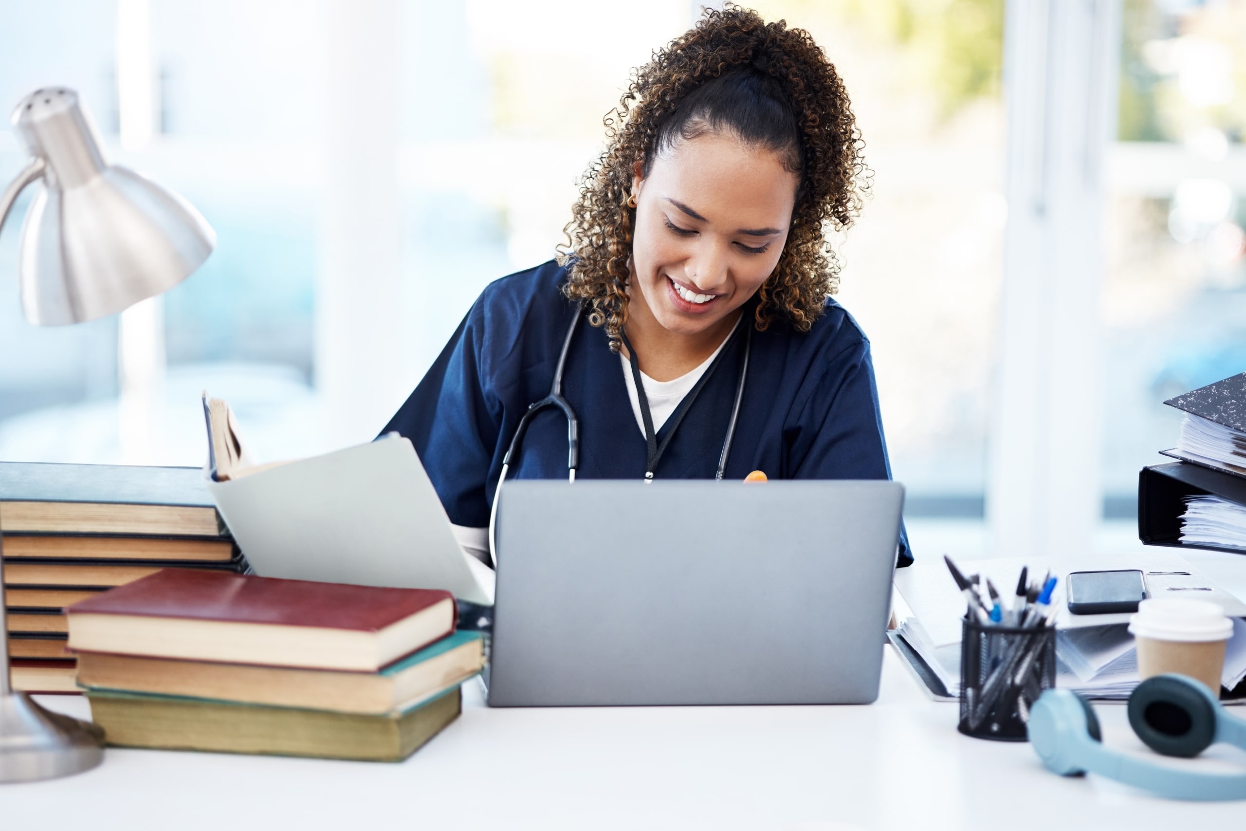 Female African-American medical professional using a laptop