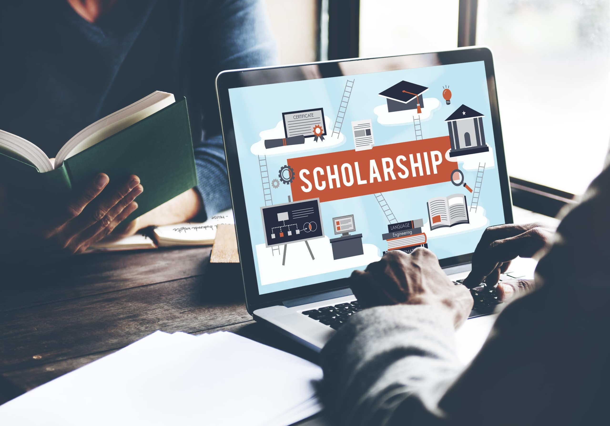 Close up of a person looking at scholarships on a computer